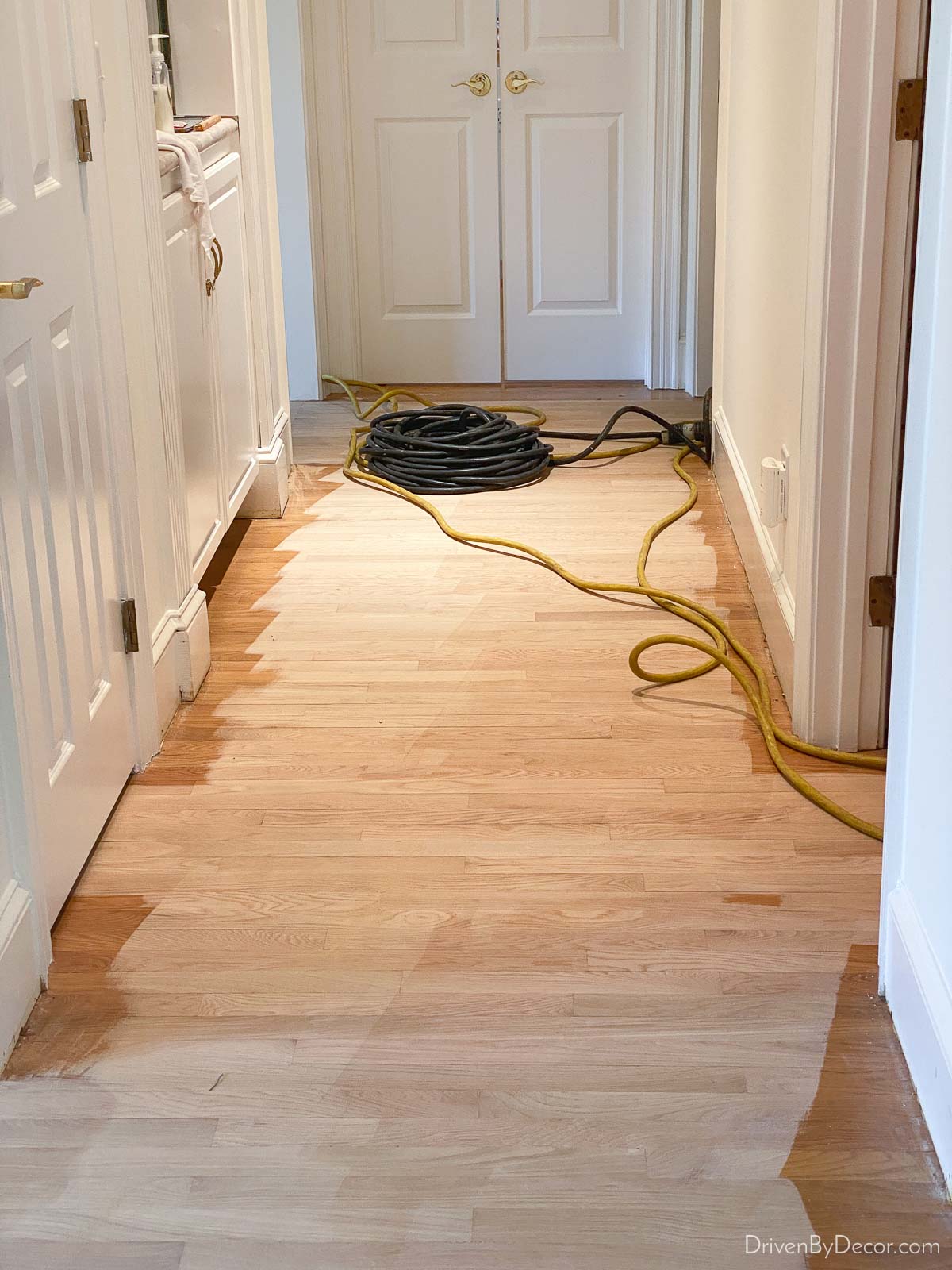 Sanding our floors as the first step in our hardwood floor refinishing