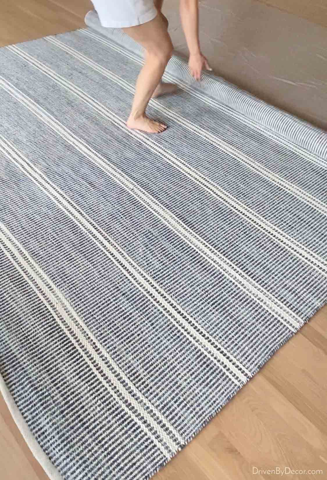 Rolling out our new rug over our refinished hardwood floors