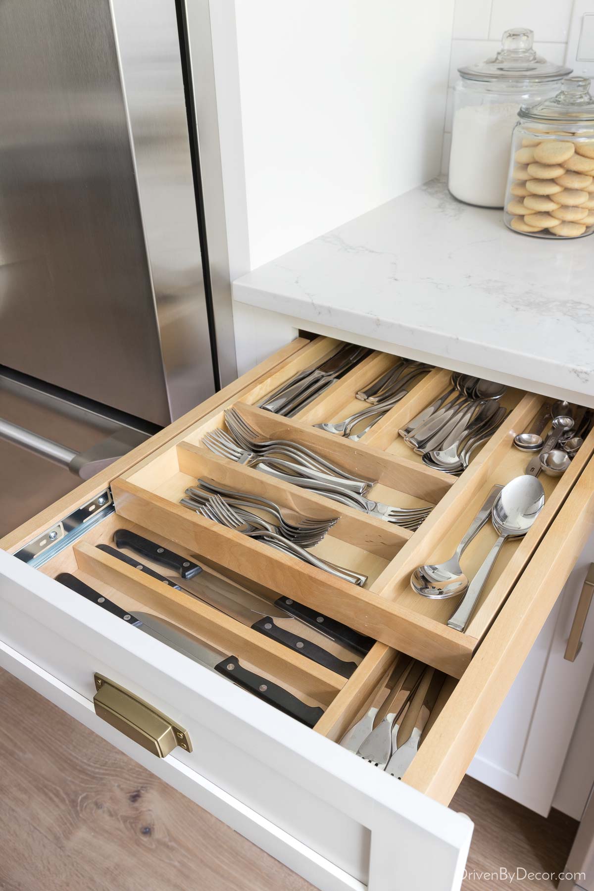 This two-tier silverware organizer allows you to store twice as much in this kitchen drawer!