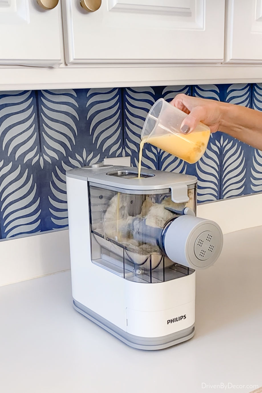 Adding the wet ingredients to the pasta making machine!