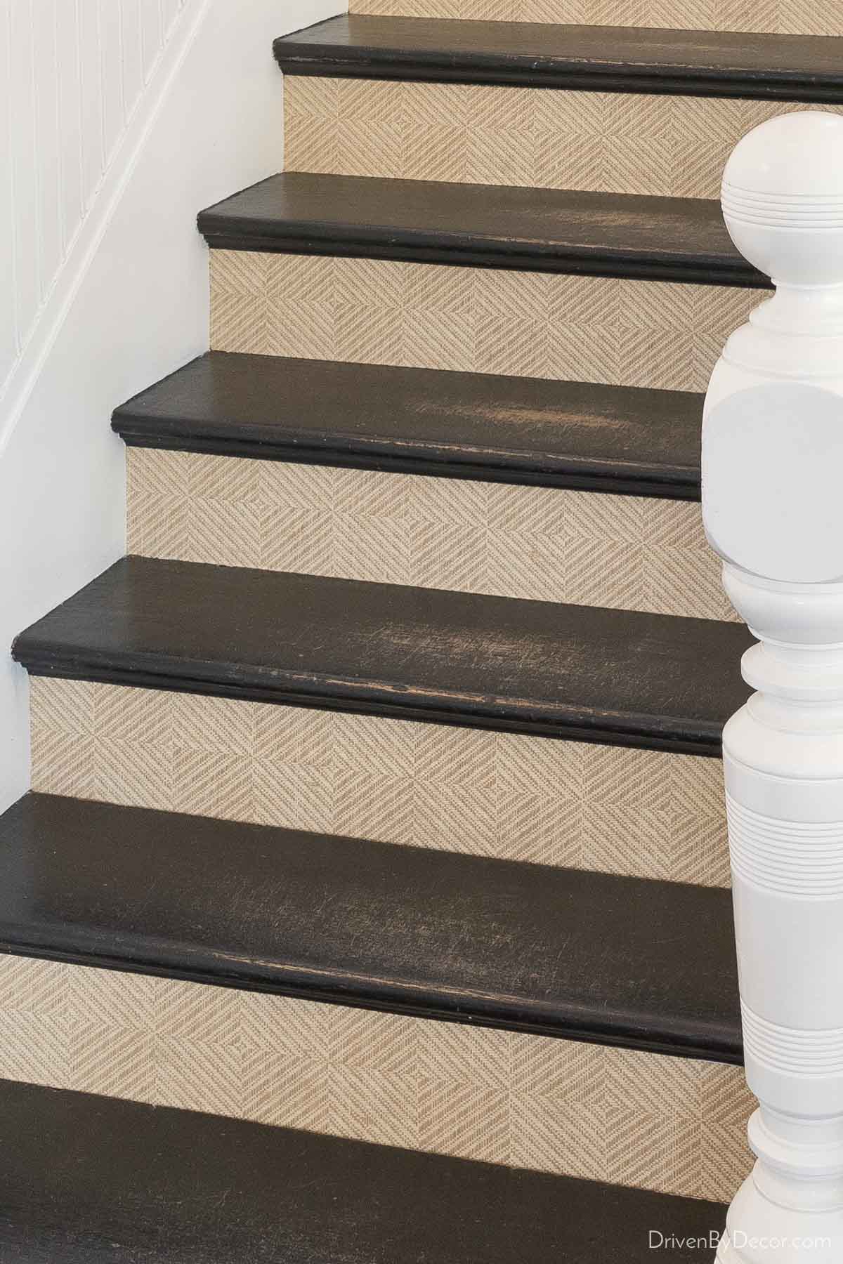 Patterned grasscloth wallpaper on the risers creates a beautiful staircase!