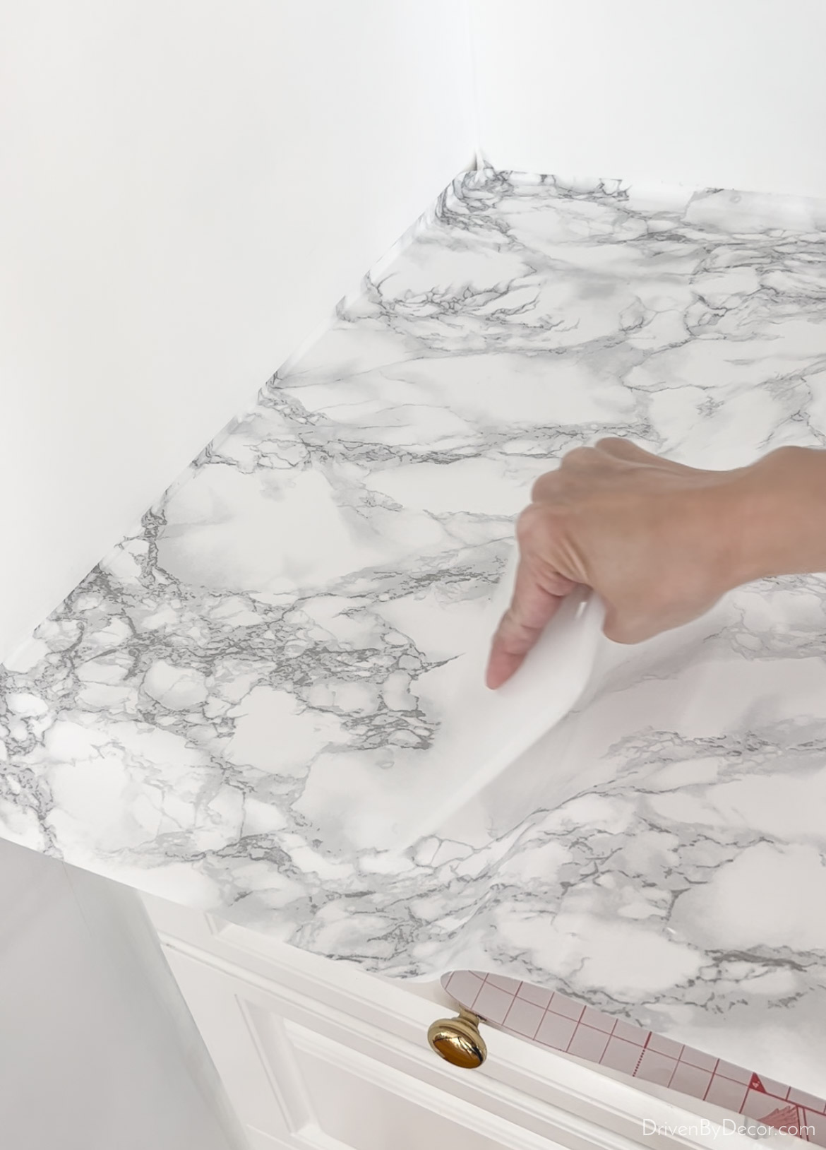 Use your smoothing tool to remove bubbles as you put your contact paper on your countertops