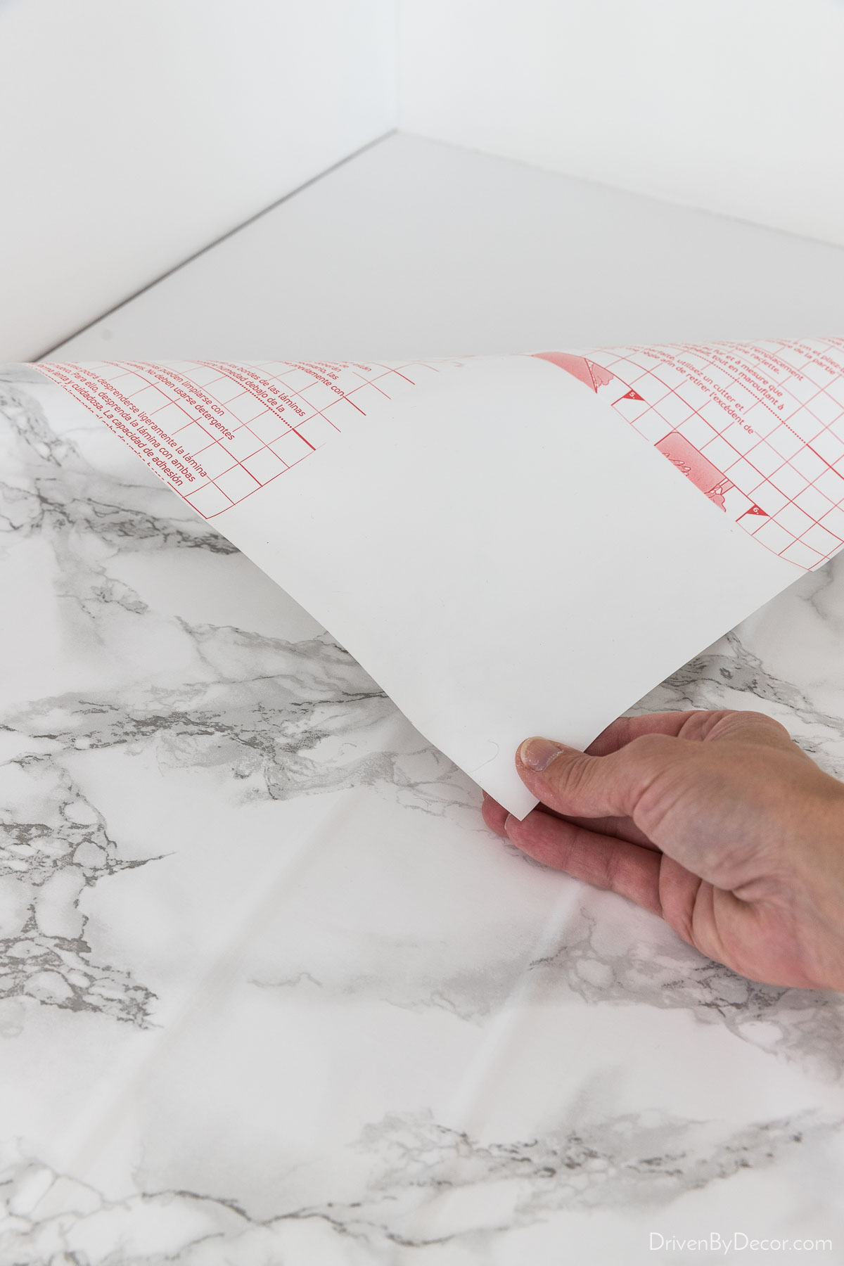 The first step in applying marble contact paper to the countertop