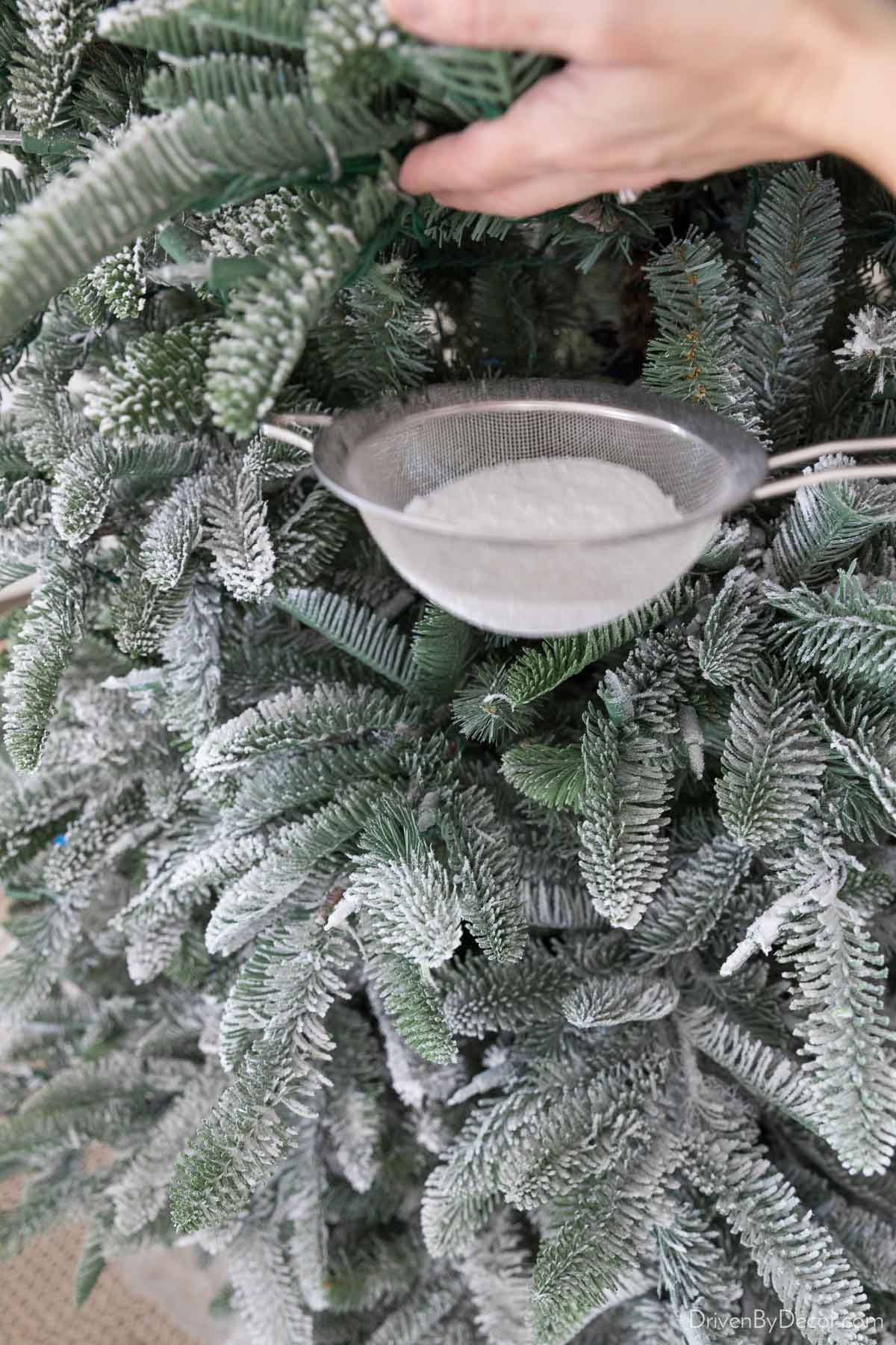 Using flocking powder to flock our Christmas tree!