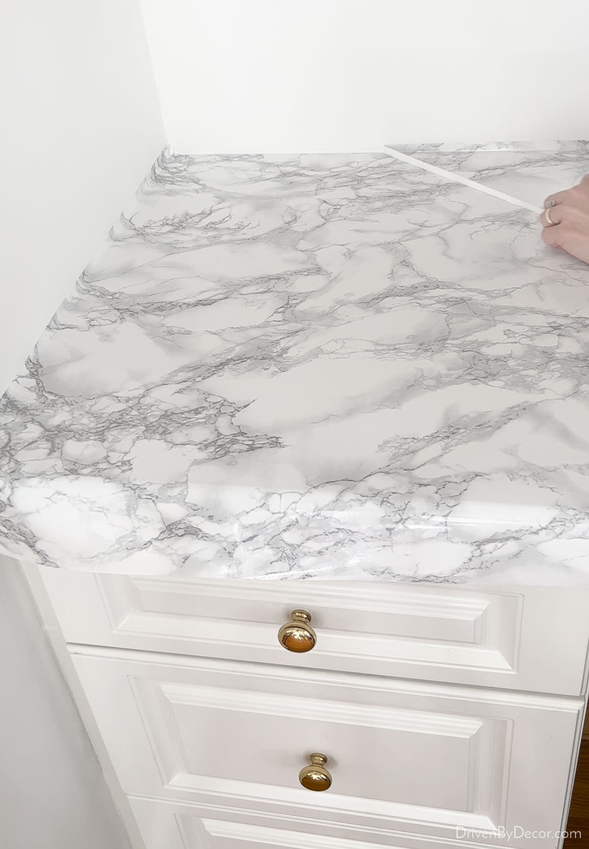 Removing the extra marble contact paper from the countertop edge
