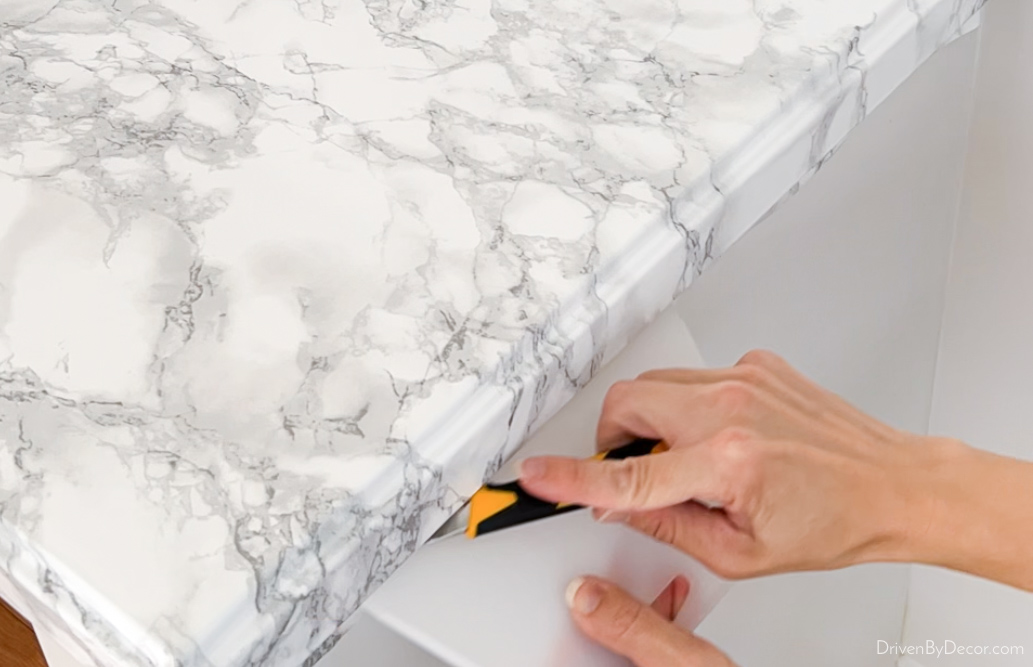 Trim off extra paper under countertop edge