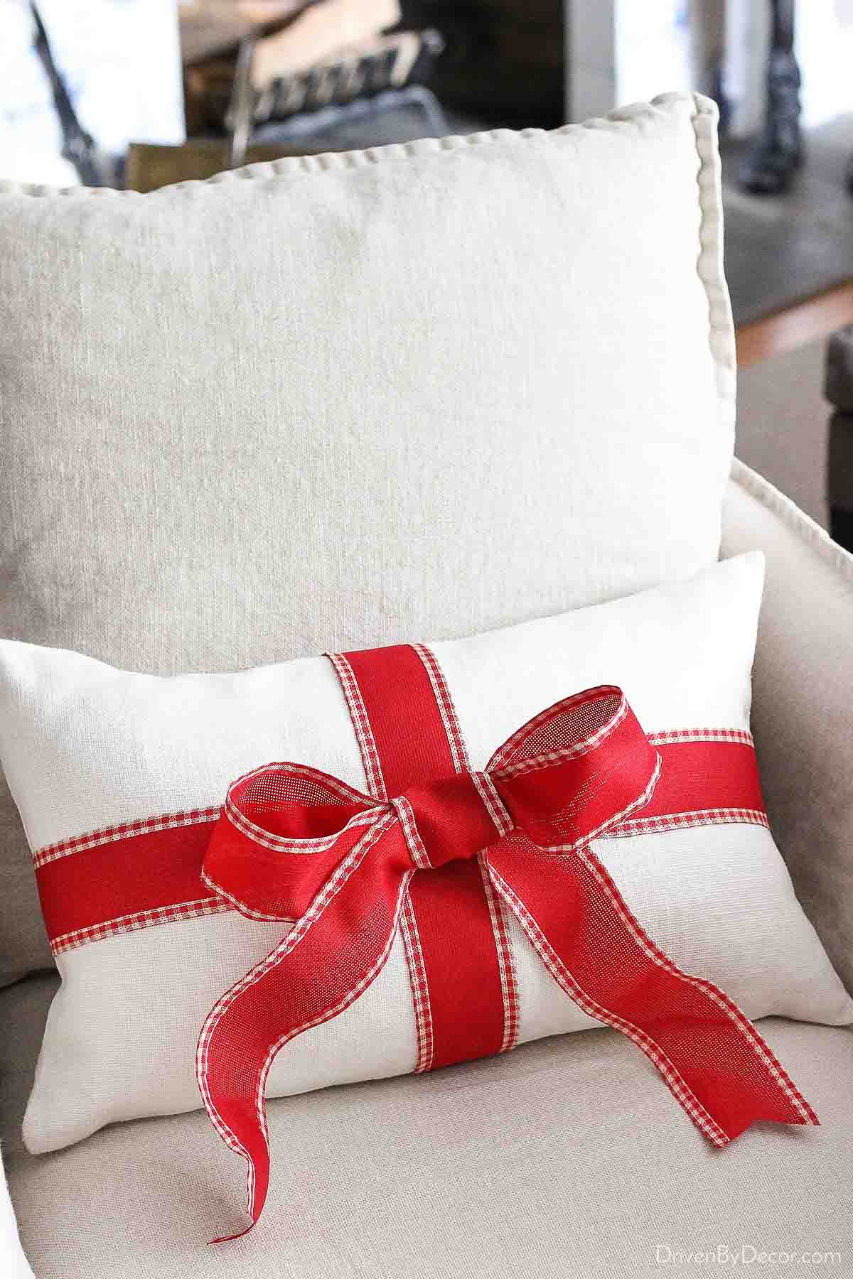 Tie a bow on a plain pillow to turn it into a Christmas pillow! Super simple decorating idea!