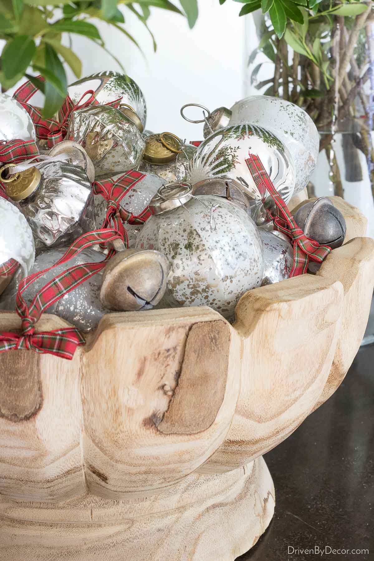 Silver ornaments displayed in this pretty wood bowl for a simple but gorgeous Christmas decoration