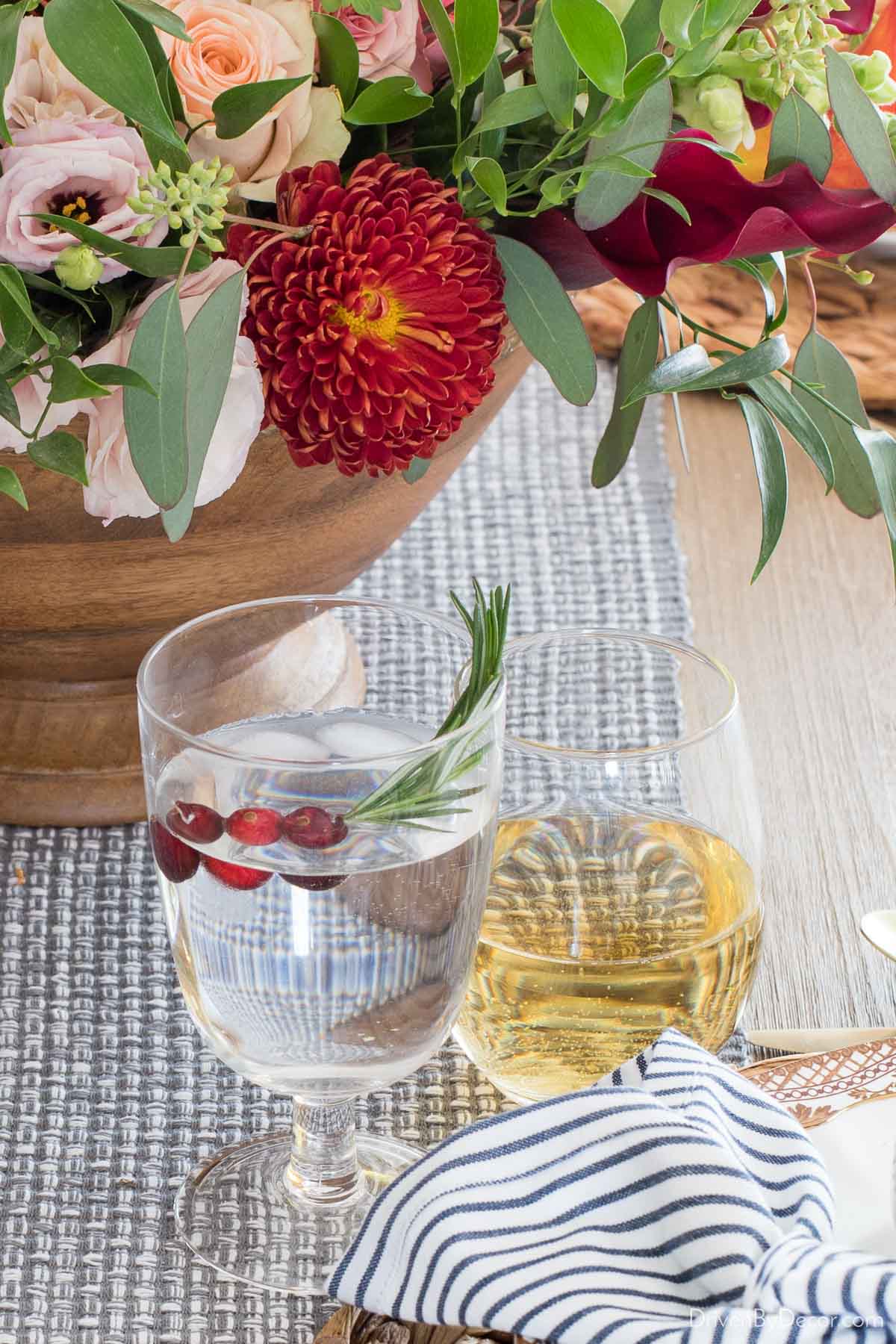 A sprig of rosemary with a few cranberries makes the perfect Thanksgiving drink garnish