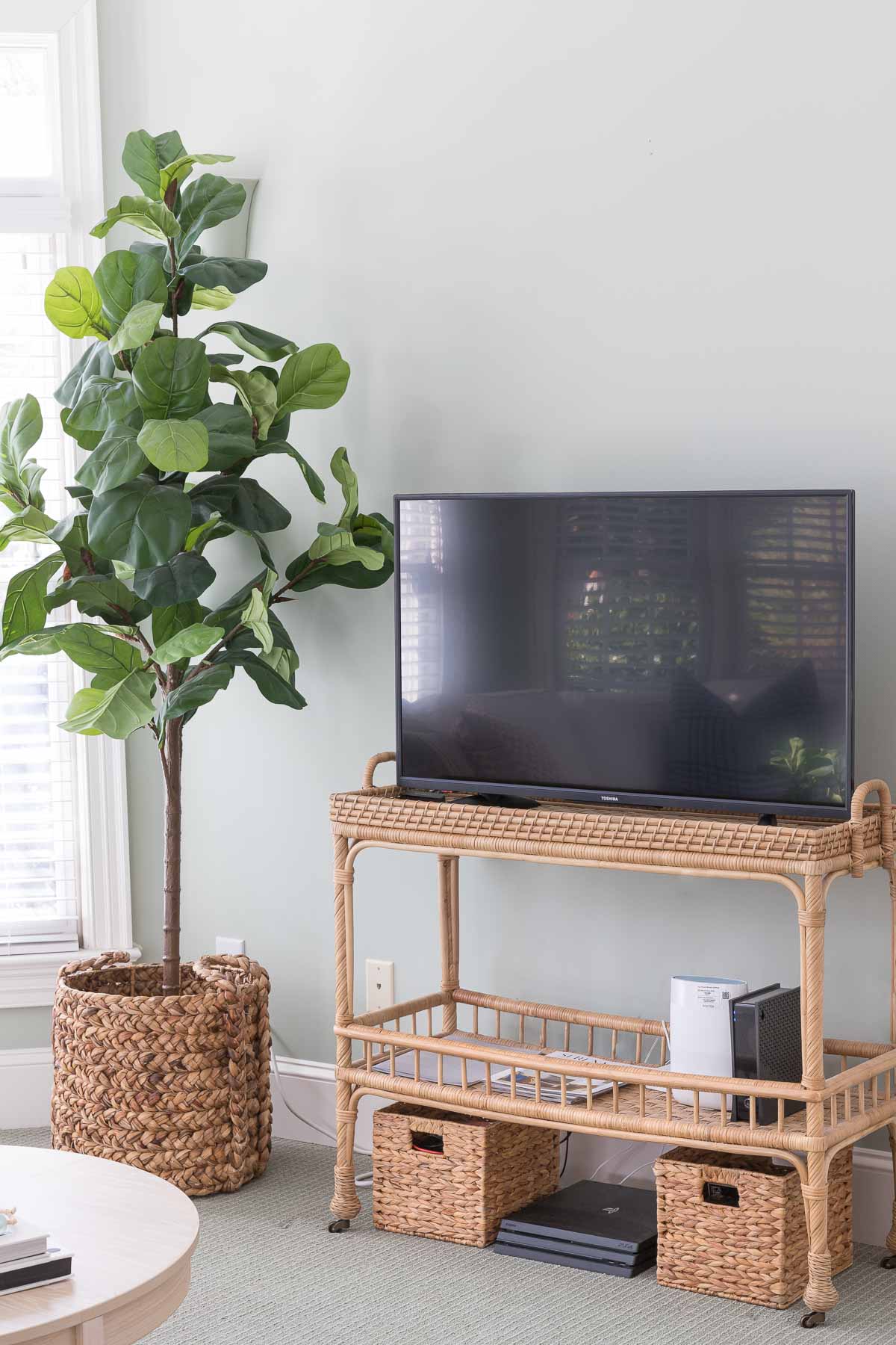 Rattan bar cart used as a TV stand