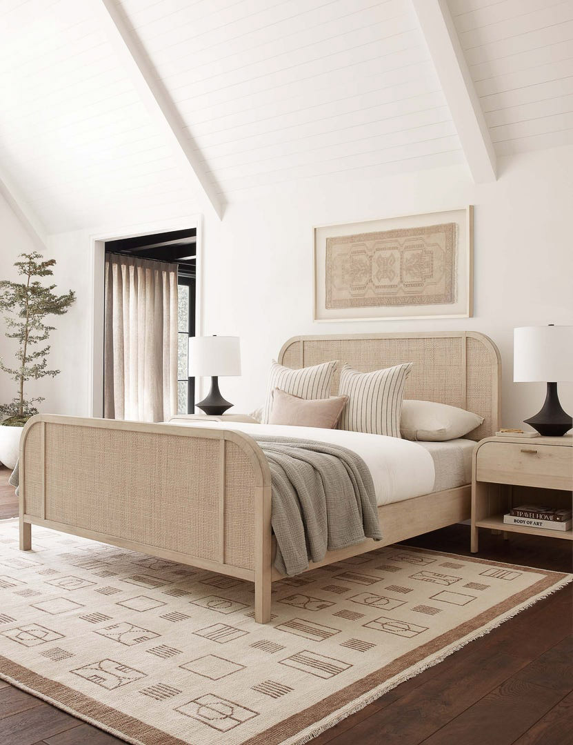 Curved furniture pieces like this bed & nightstand are a 2022 home design trend!