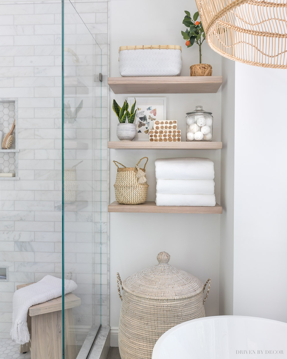 Floating wood shelves add a ton of storage space in small bathrooms