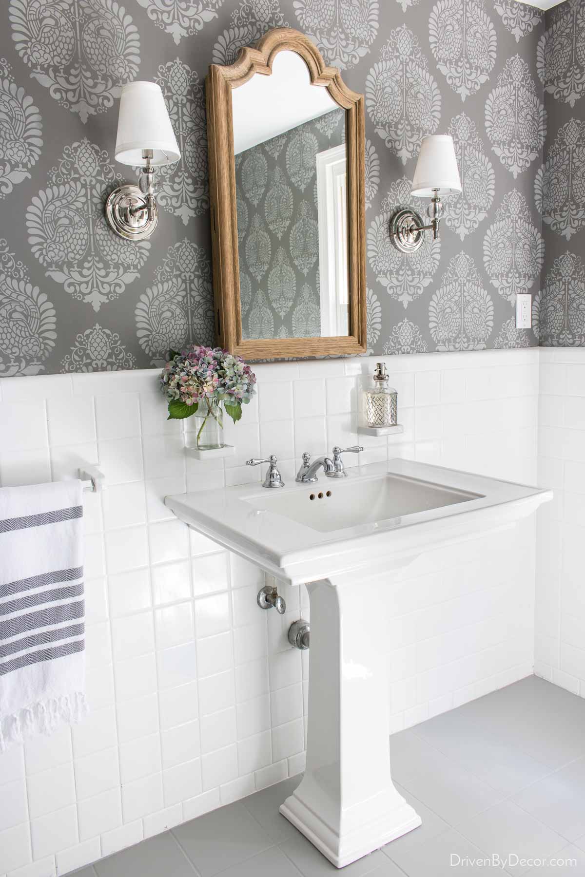 The mirror over the sink is actually a recessed medicine cabinet - perfect for extra bathroom storage!