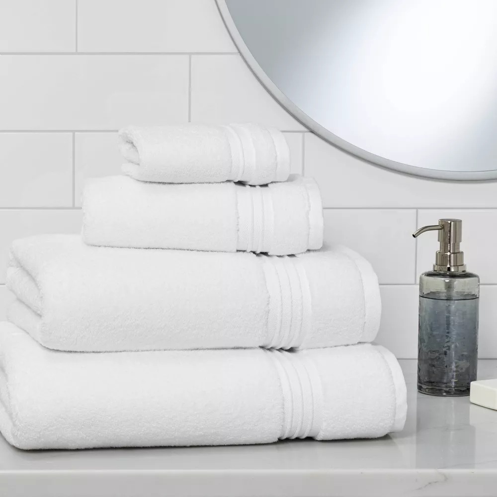 Stack of fluffy white towels that are the best budget friendly bath towels