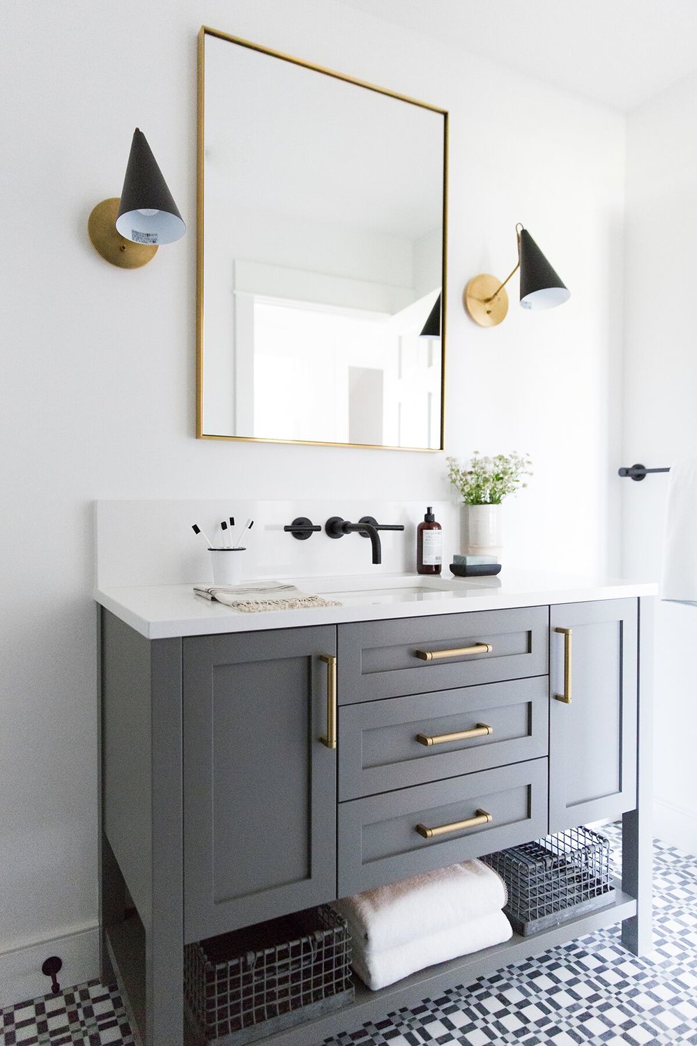 Love this use of unique modern sconces flanking the mirror above this bathroom vanity