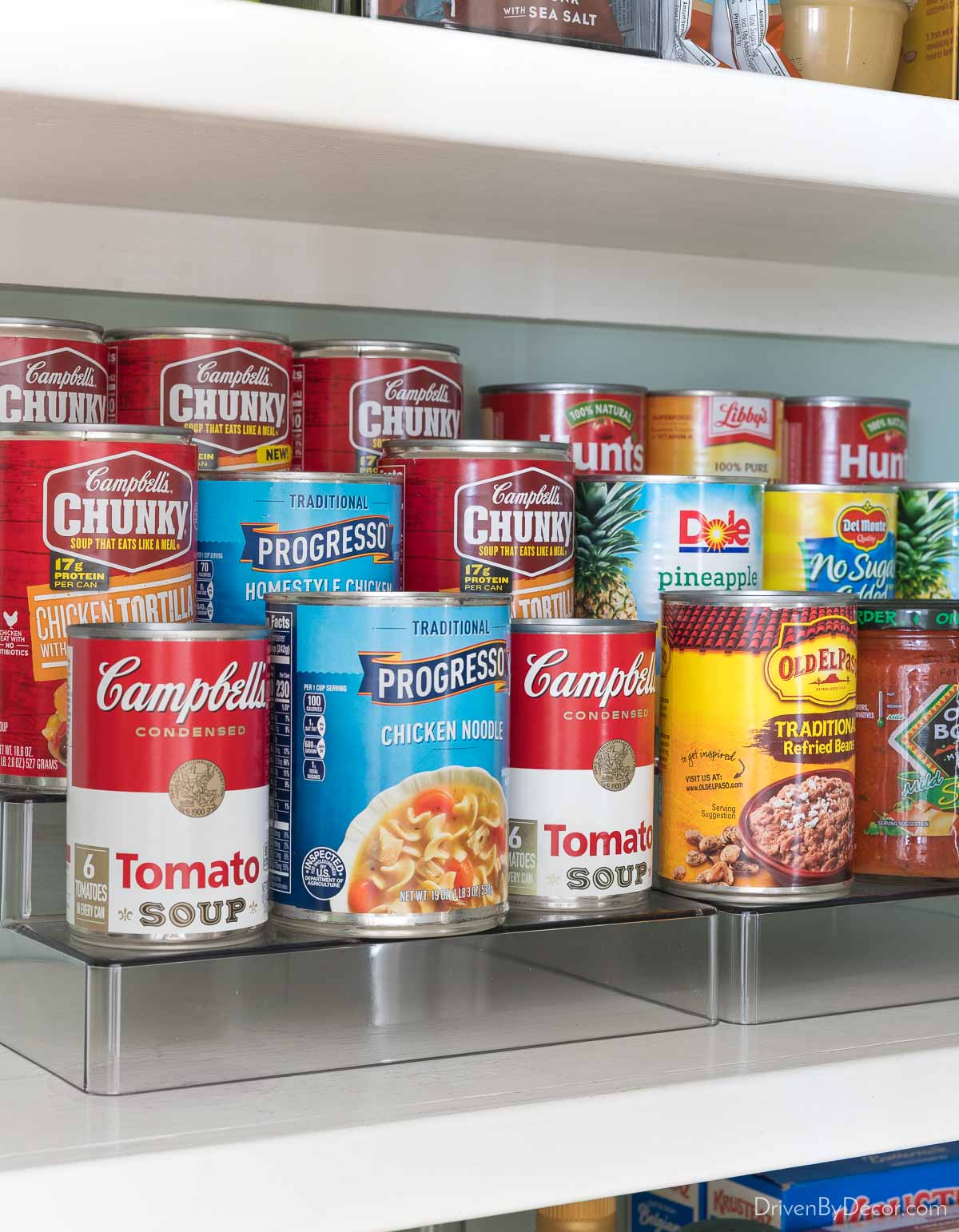Organized kitchen cabinet with tiered organizer for cans