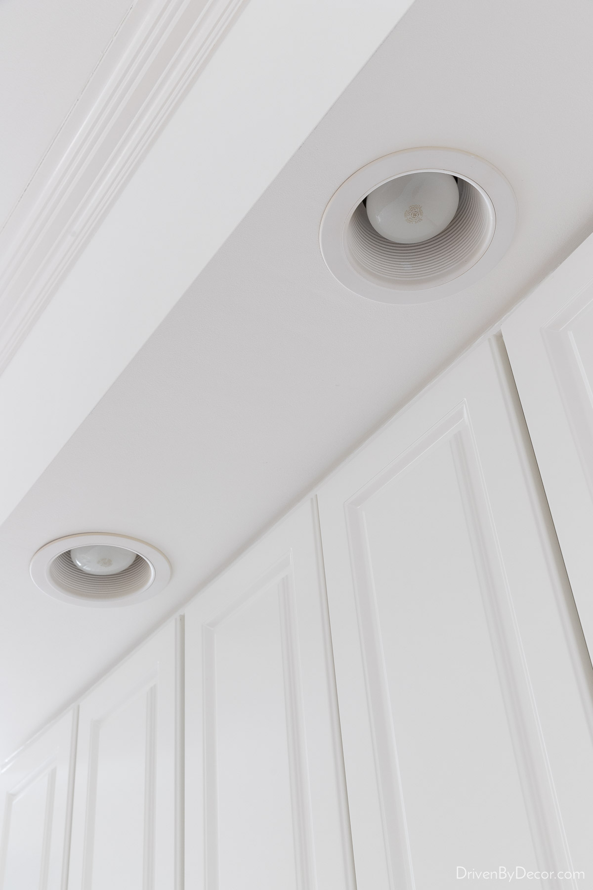 Spray paint your recessed lighting white as part of a kitchen remodel on a budget!