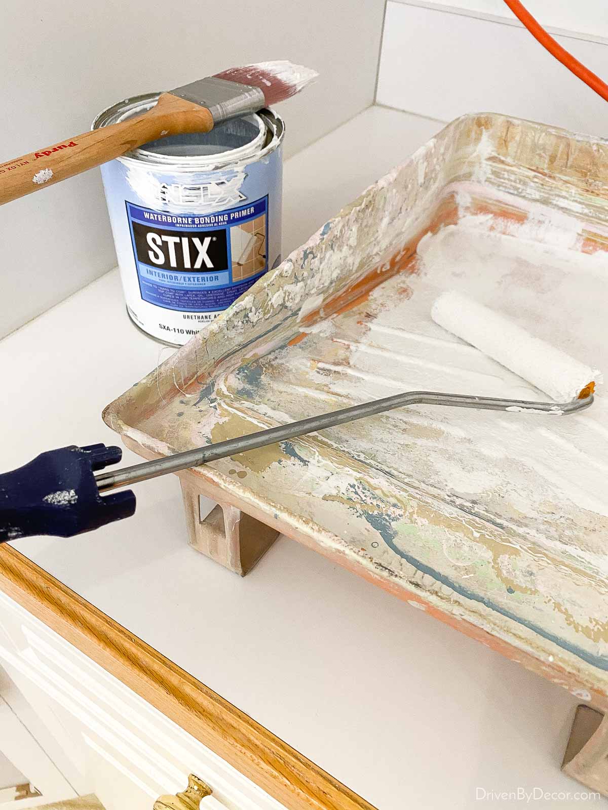 Priming our kitchen cabinet frames before painting