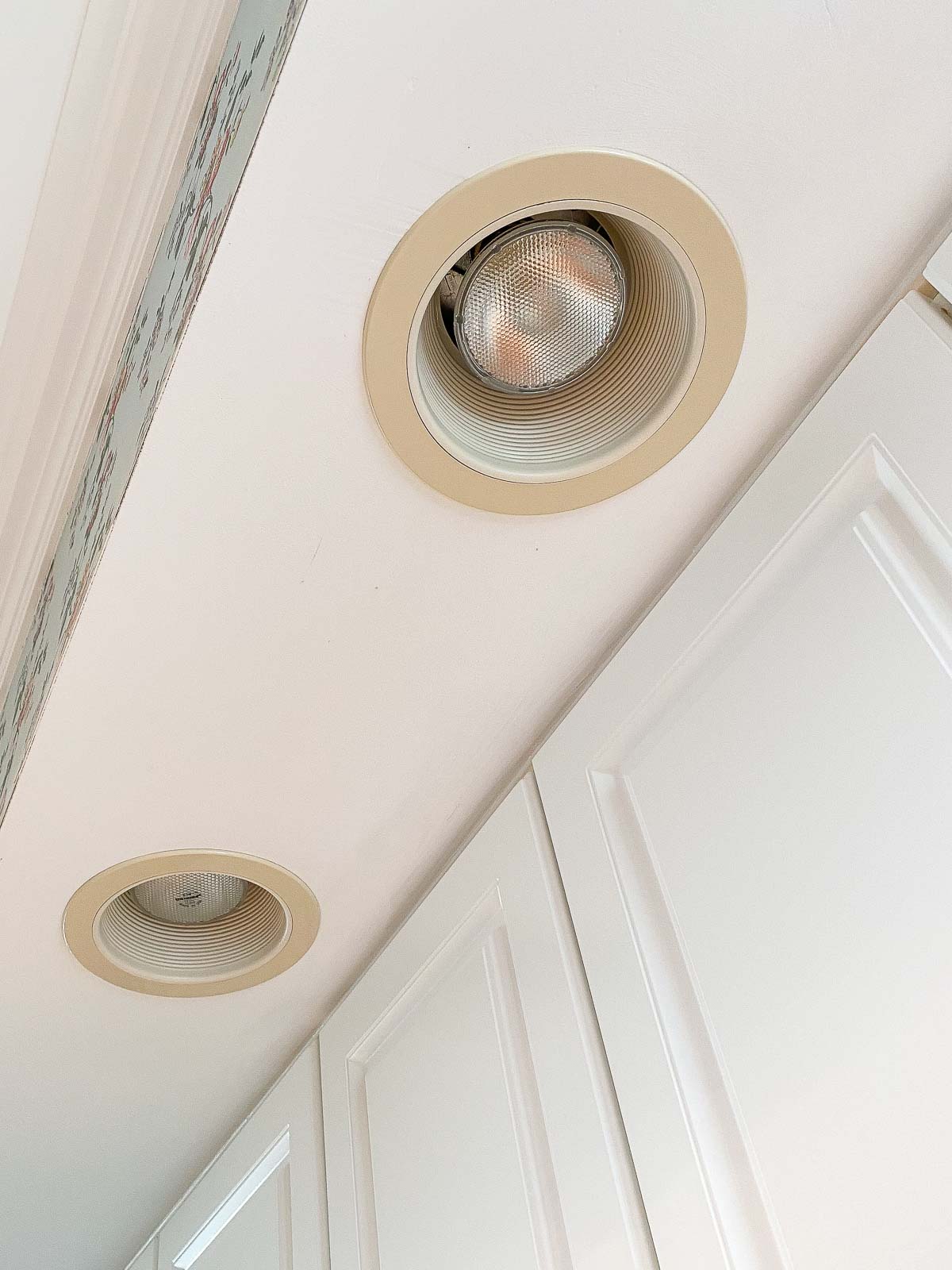 Yellowed recessed lighting trim I spray painted as part of my budget kitchen remodel