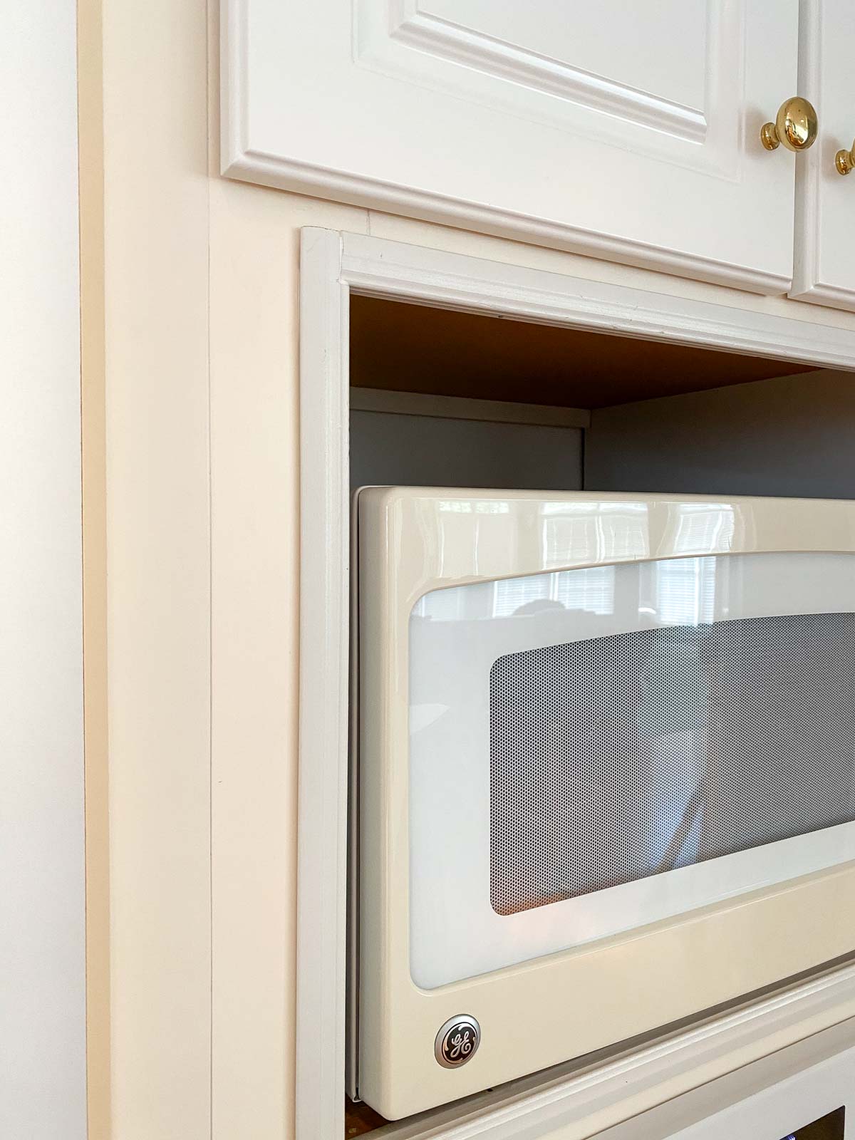 Painting the yellowed cabinet frames as part of our budget kitchen remodel