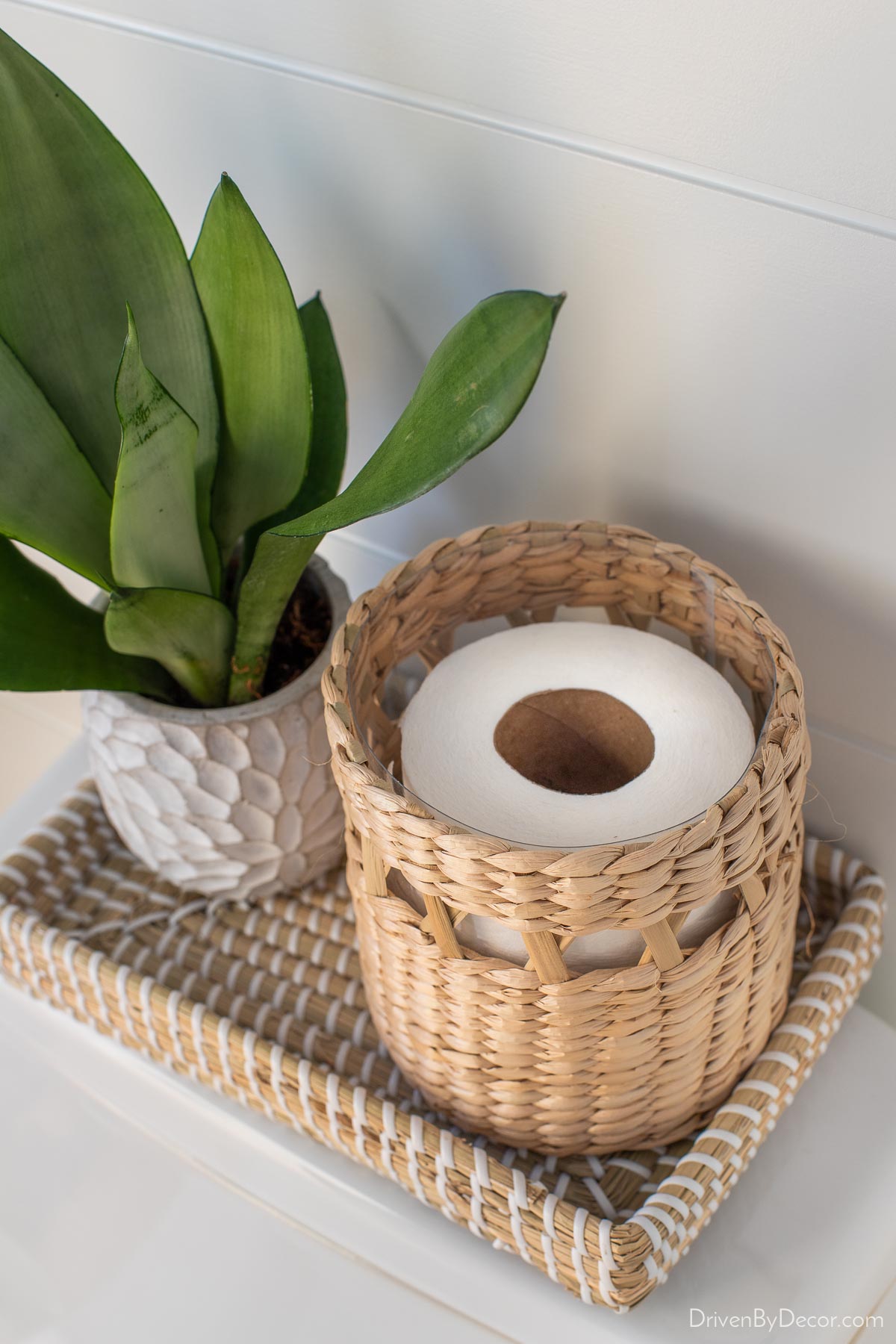 This woven canister is the perfect size for storing an extra roll of toilet paper