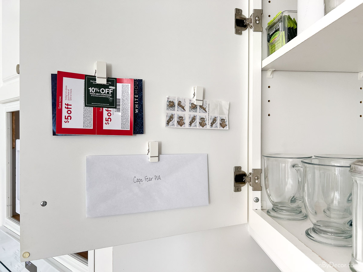 Command clips added to the back of kitchen cabinet doors - great organization idea!