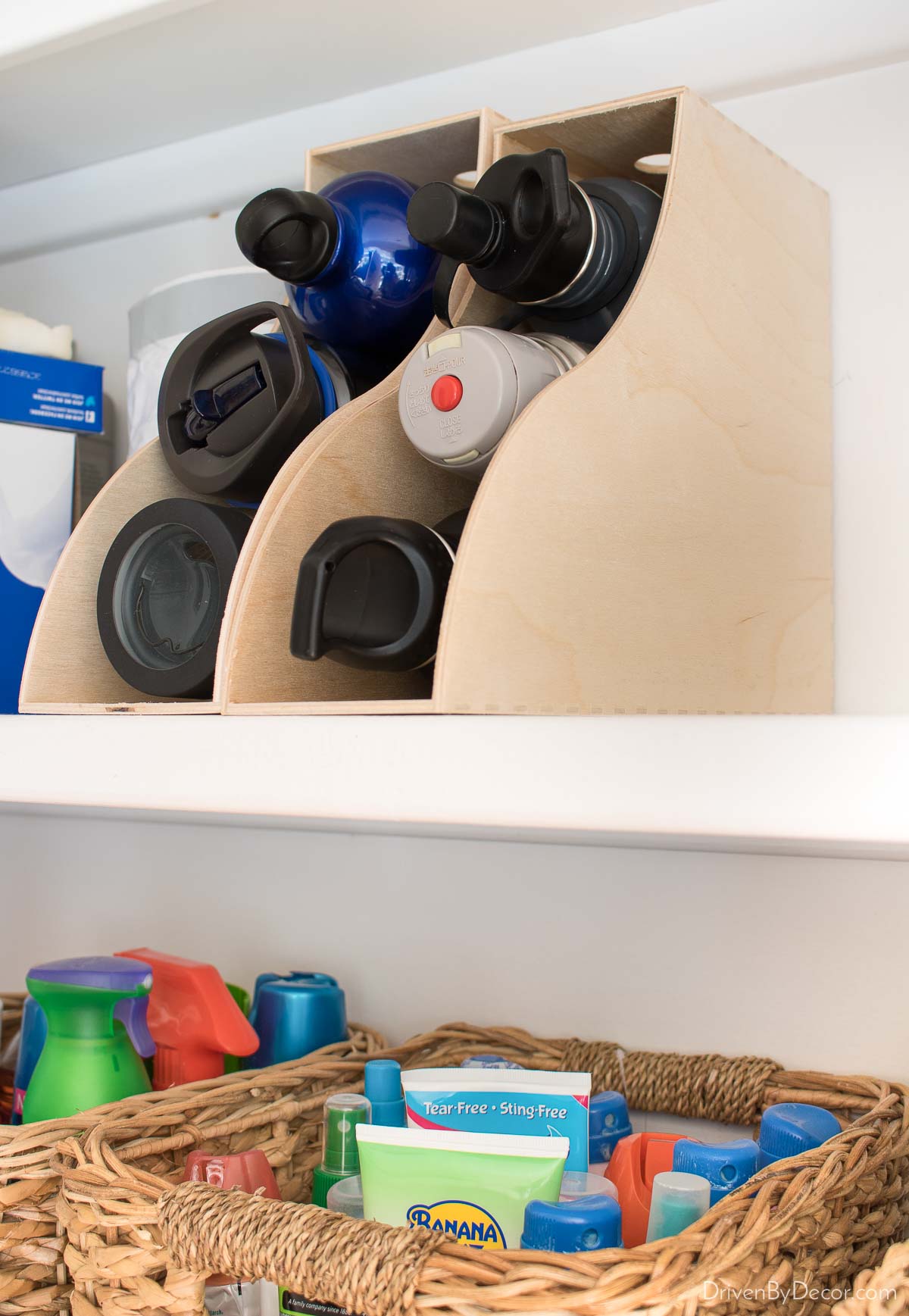 Magazine racks flipped on their back make great water bottle holders for kitchen cabinet organization