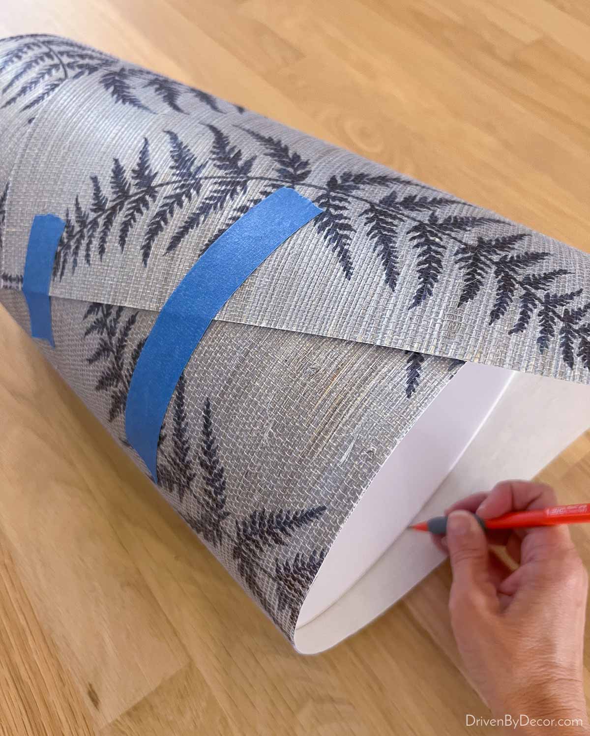 Grasscloth wallpaper wrapped around a waste basket to cut down to size