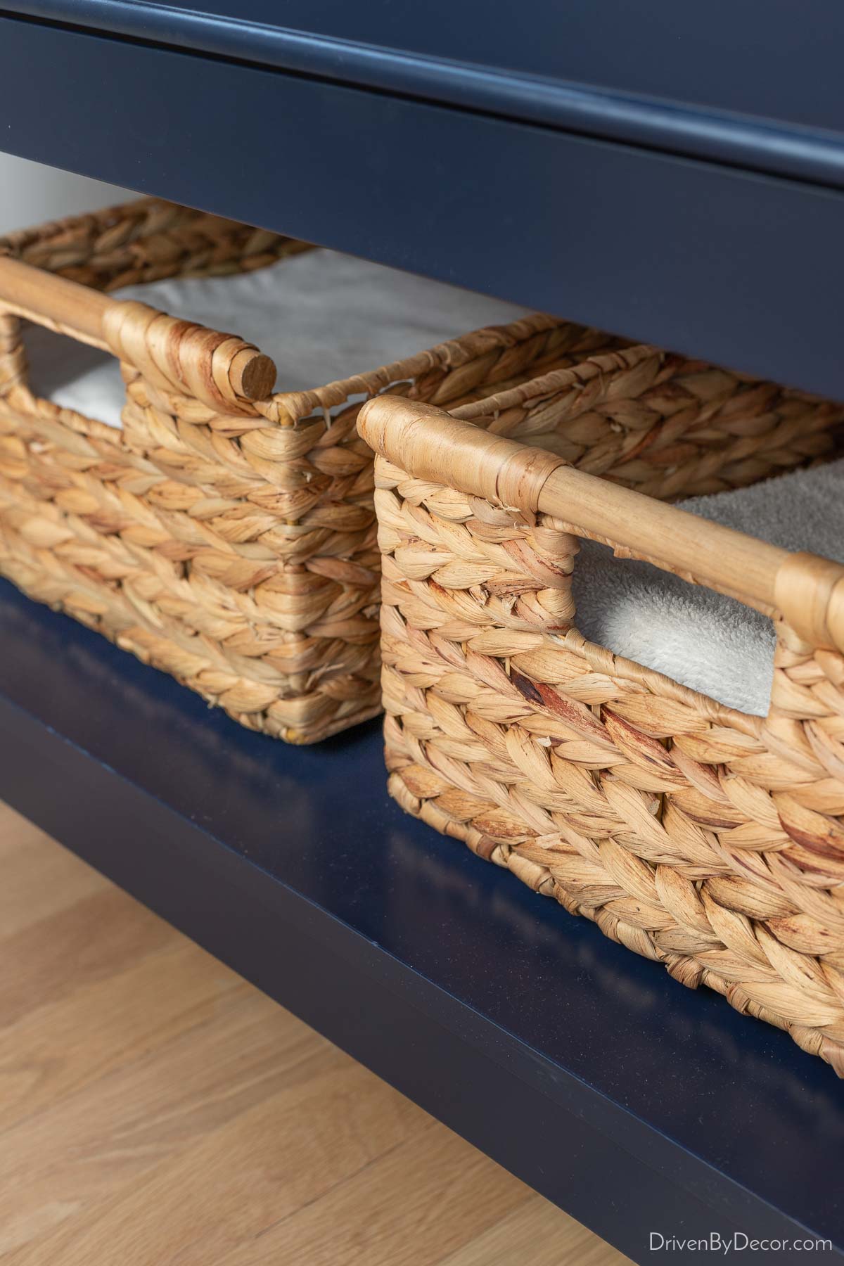 Woven baskets on the shelf of our bathroom vanity