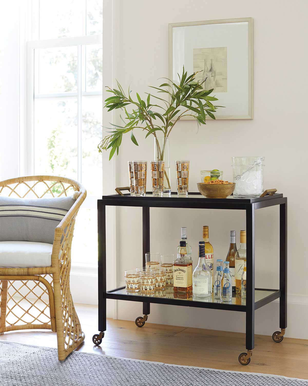 Bar cart with art hung above it as dining room wall decor