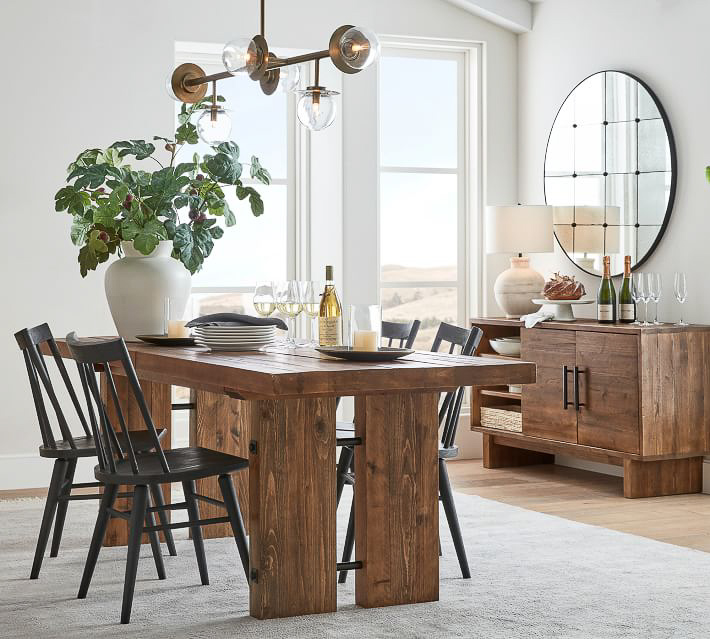 Large round mirror on wall of dining room as gorgeous decor piece