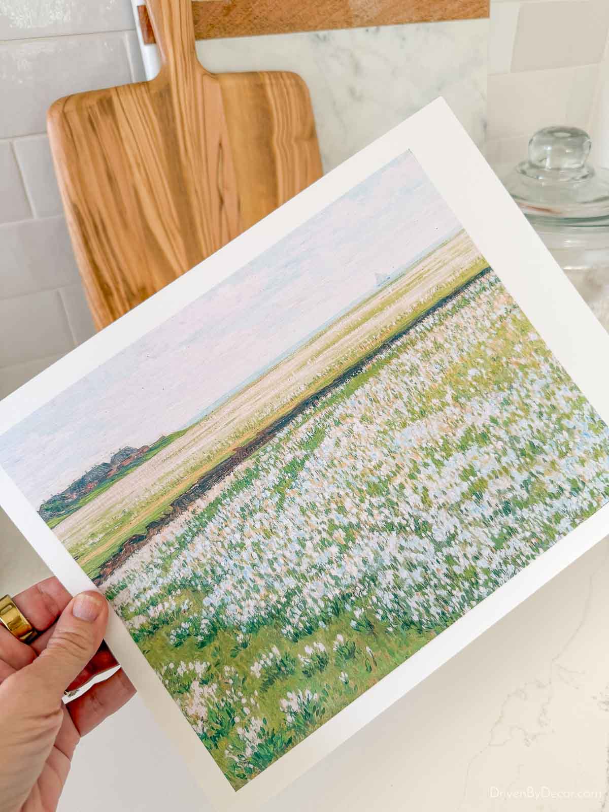 Hand holding spring landscape print