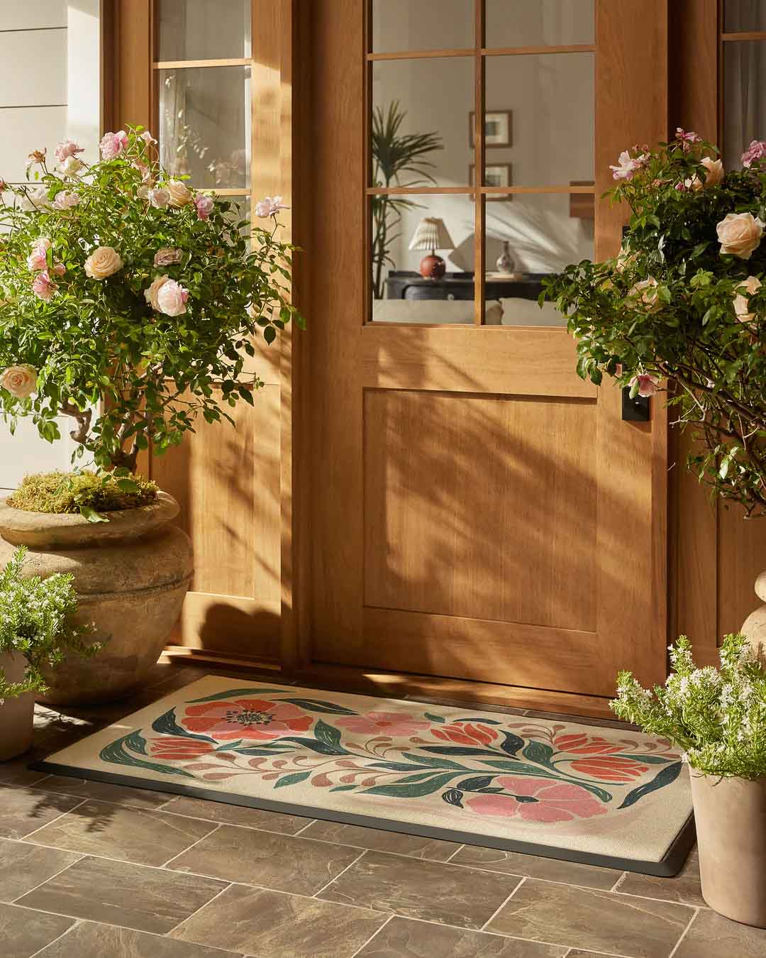 Colorful floral spring doormat in front of door