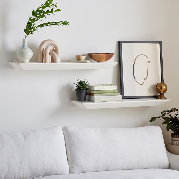 Floating white shelves that could work over a toilet