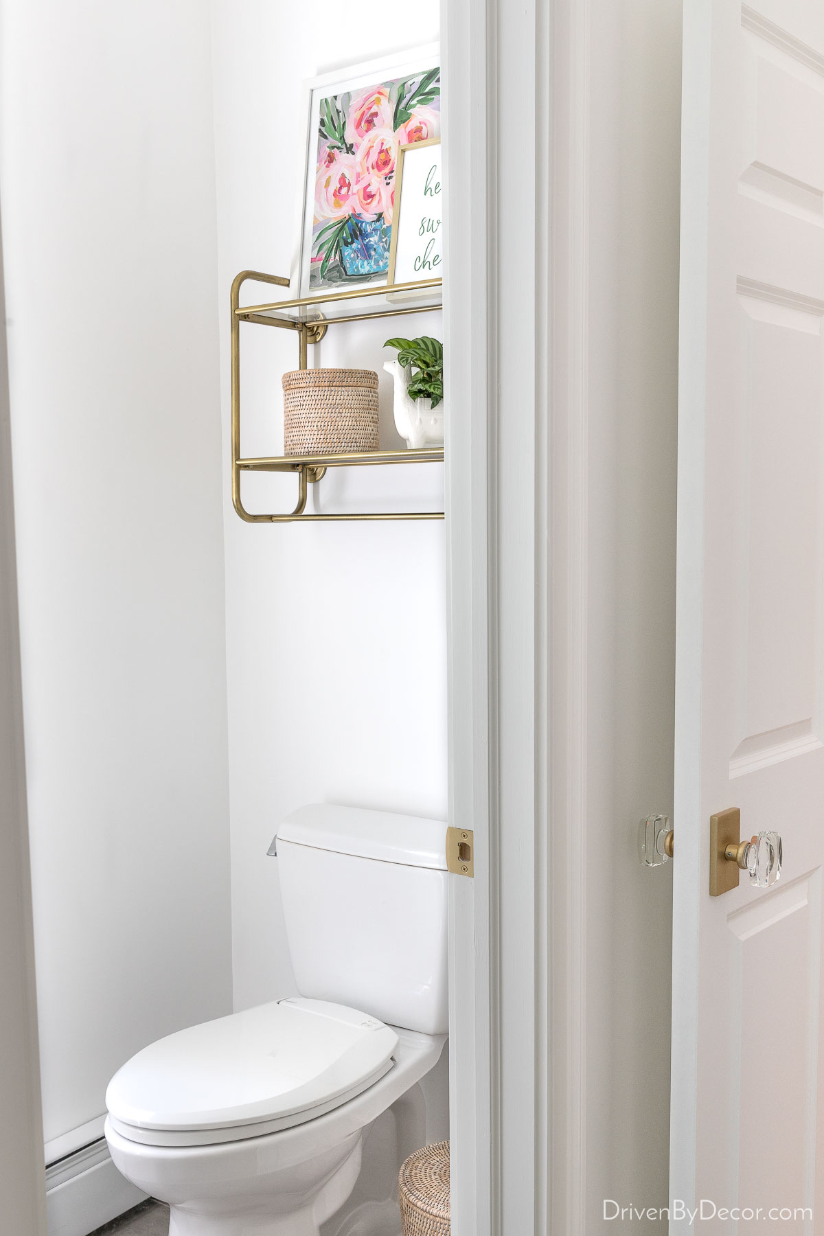 Open brass shelving over toilet