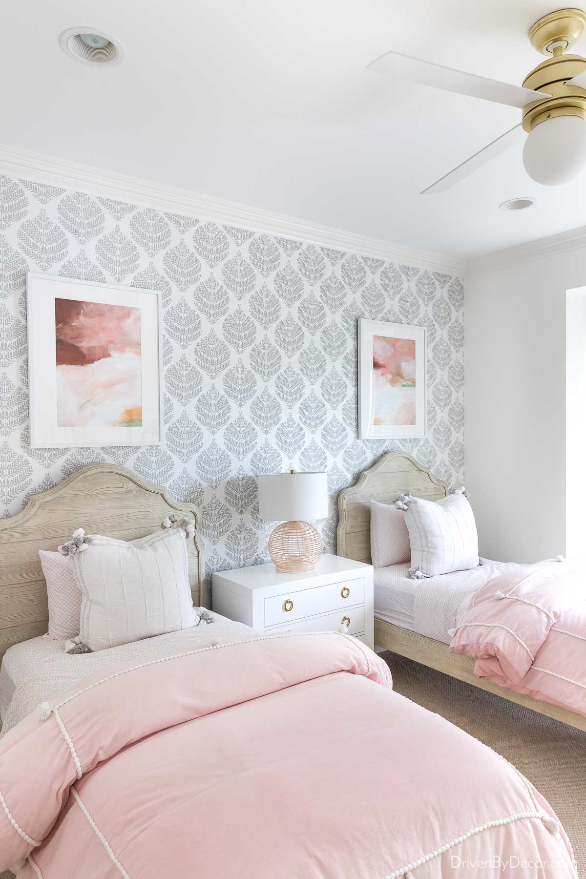 Gray and white damask wallpaper installation on an accent wall