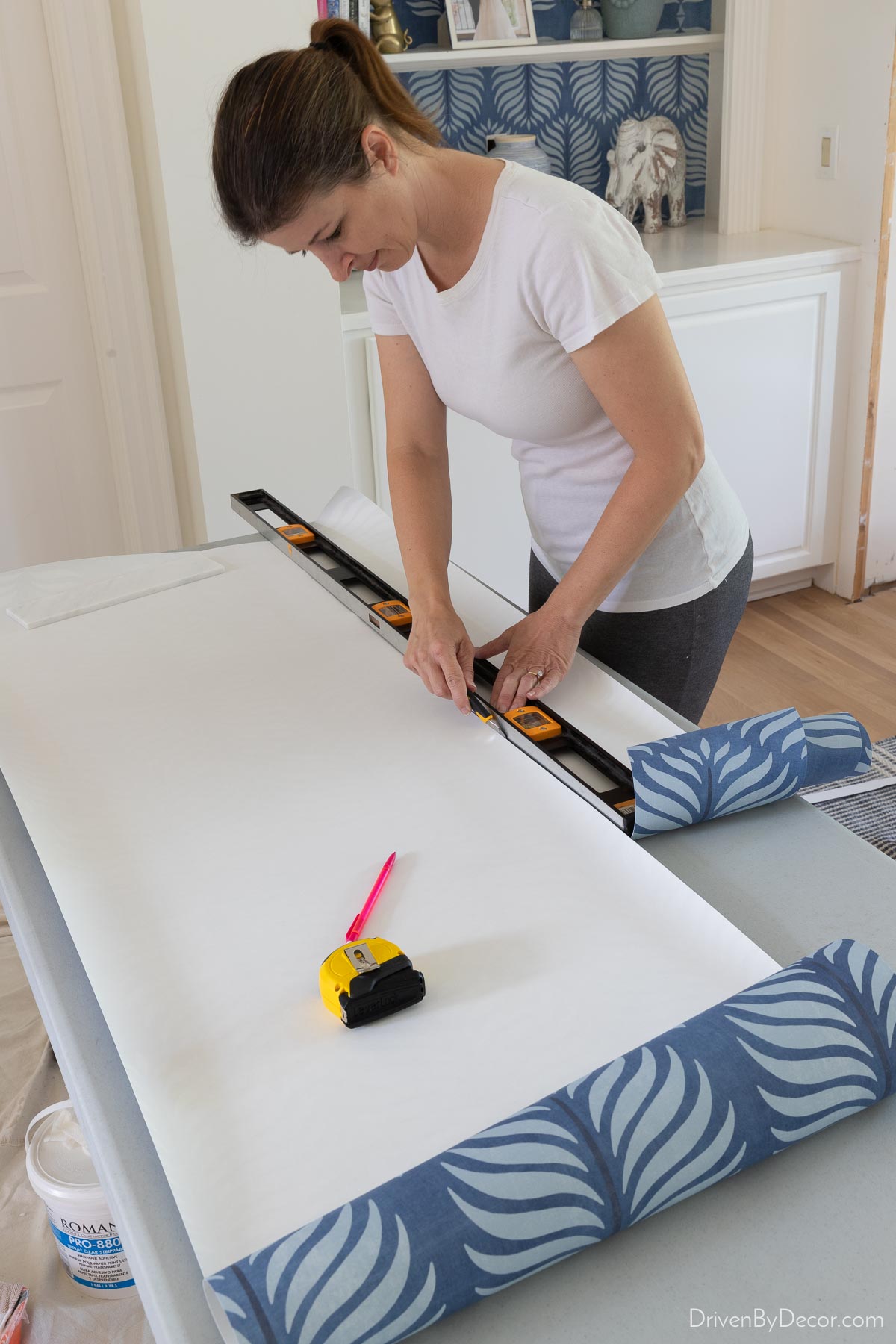 Cutting the wallpaper strip in two for wallpaper installation in a corner