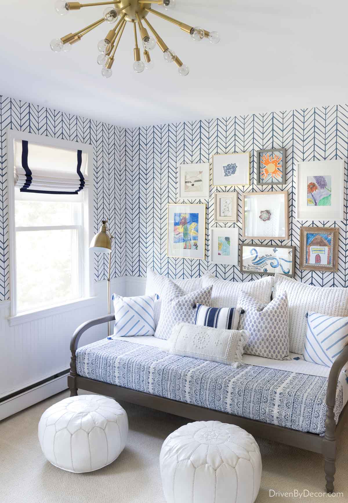 Blue and white wallpaper installation above beadboard