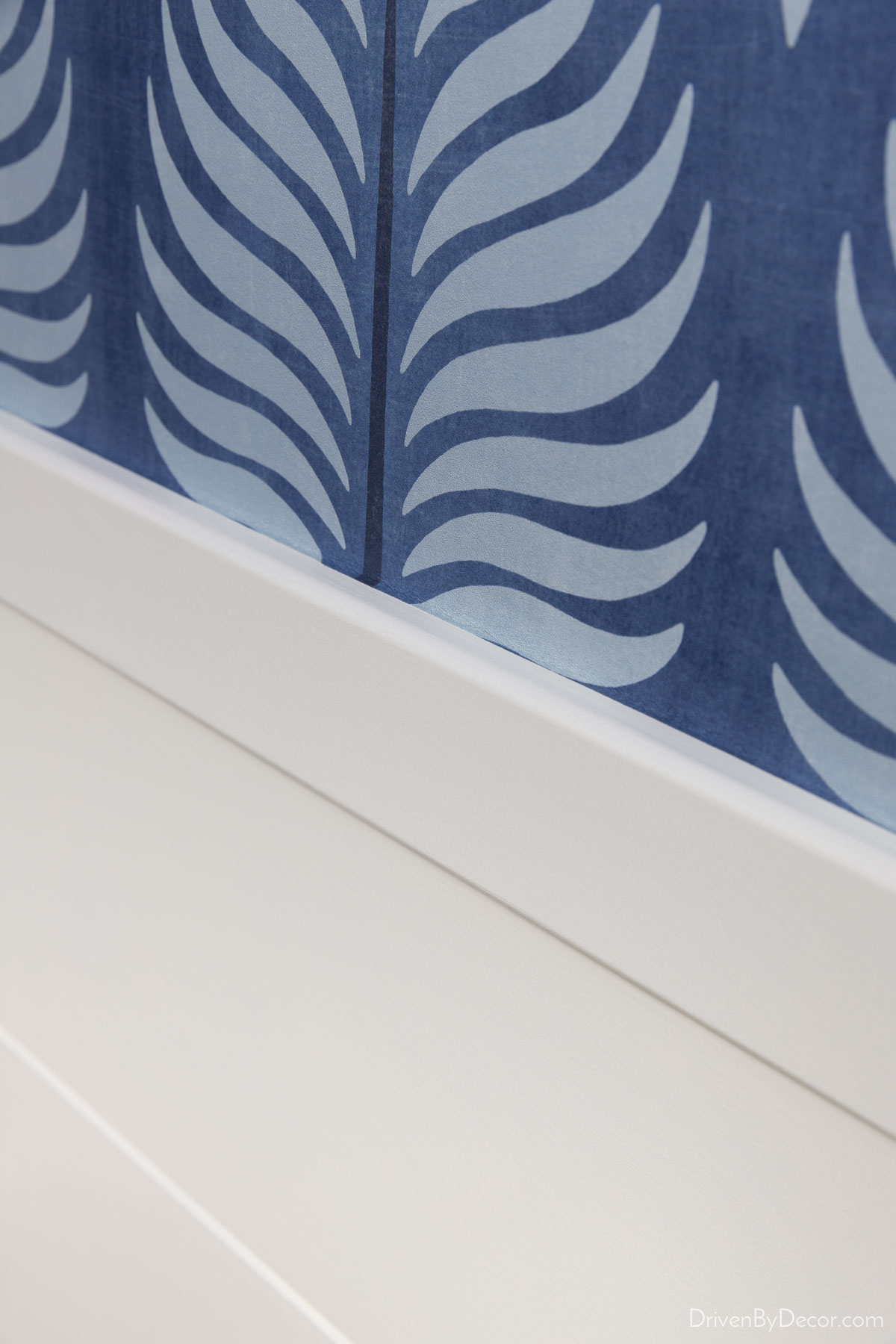 Wallpaper strip after excess trimmed at bottom