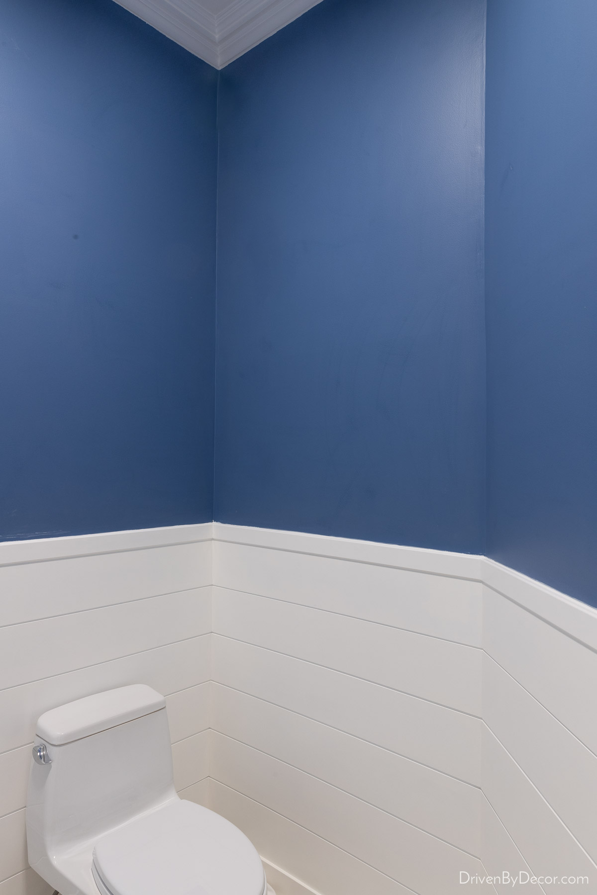 Blue tinted wall sizer applied to walls before wallpaper installation