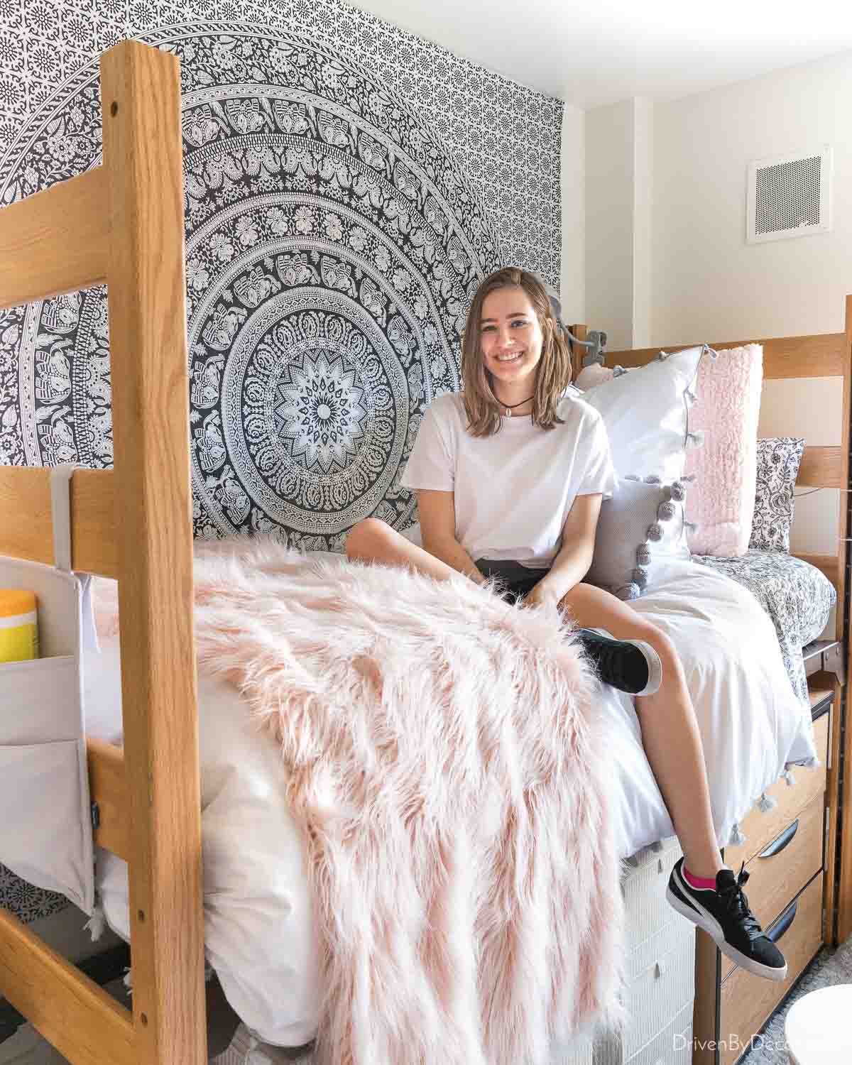 A large scale black and white tapestry on the wall in a dorm room