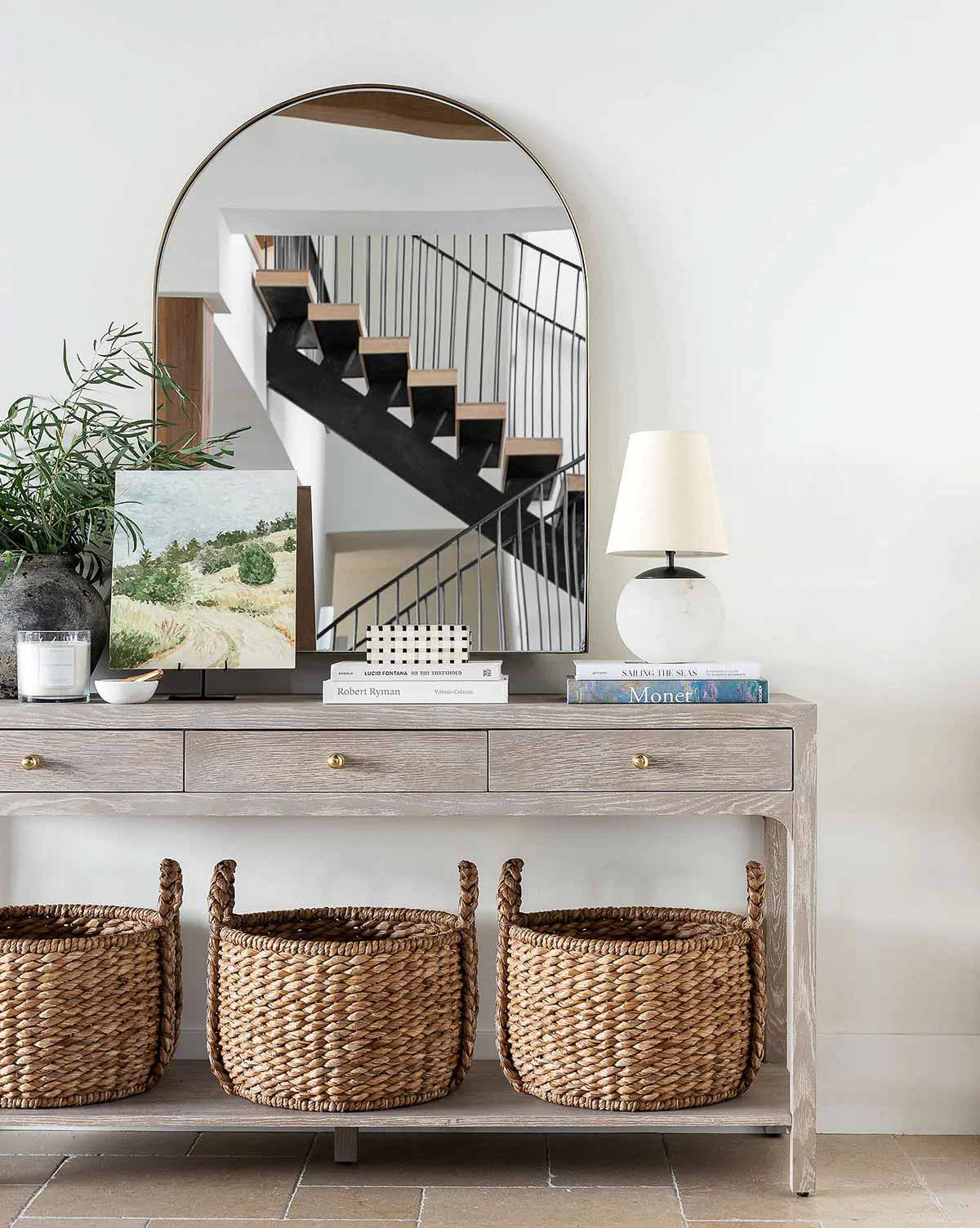 Arched mirror over a console table