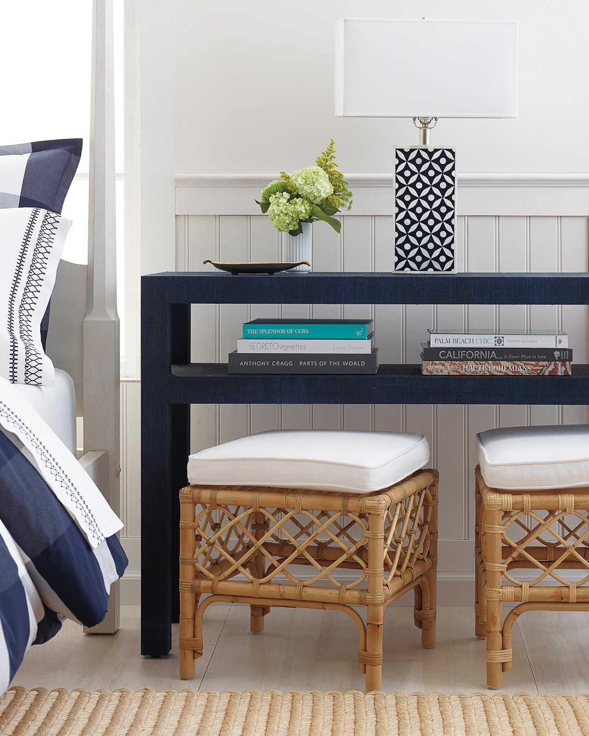 A pair of rattan stools tucked under a console table