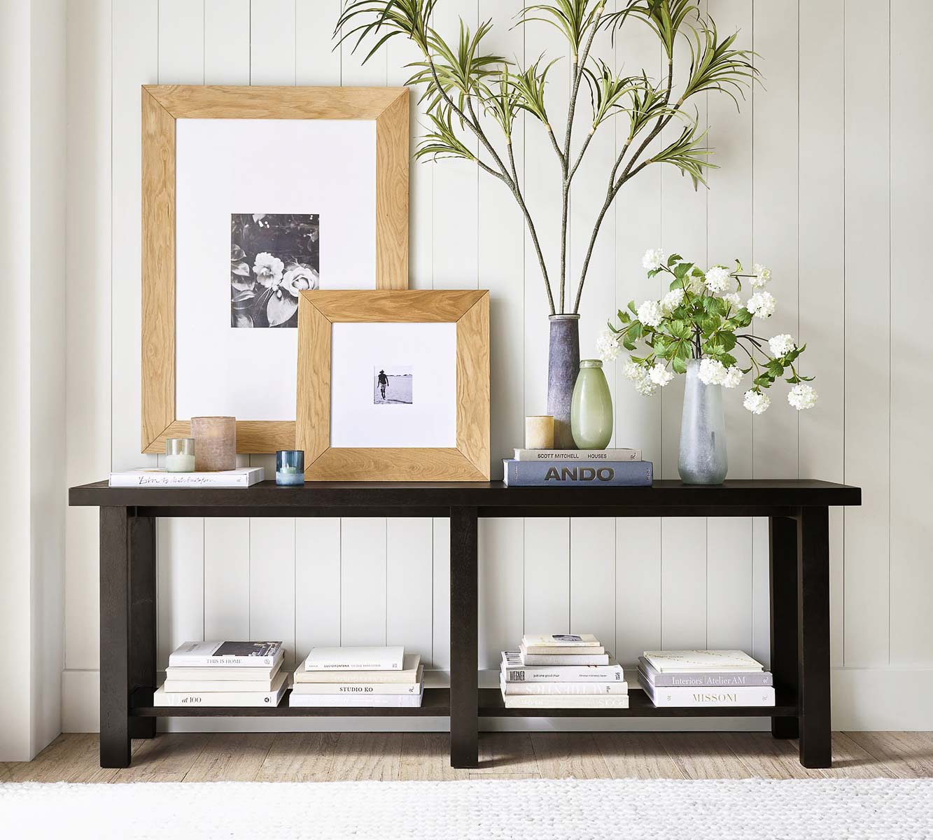 Wood framed art layered on a console table