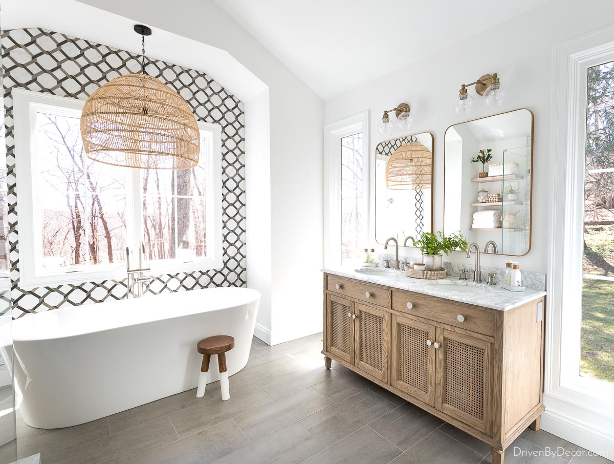 The lighting in our primary bathroom - rattan pendant over bathtub and twin sconces over vanity
