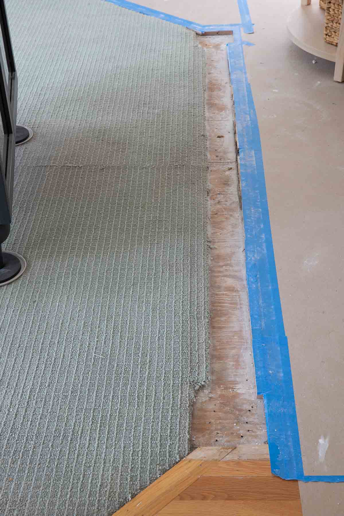 Different flooring that was separated by a half wall