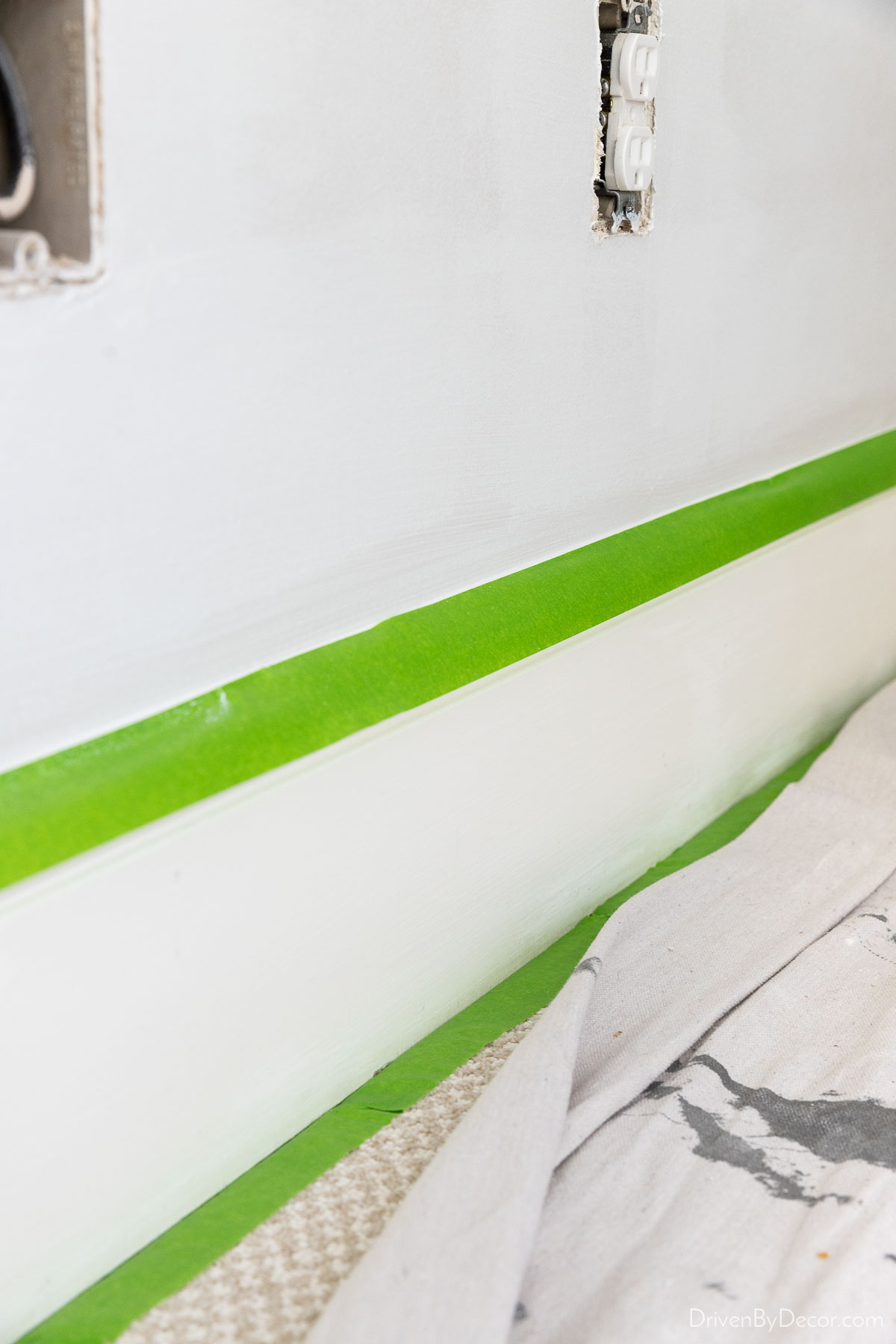 Apply painter's tape to top of baseboards to shield from paint splatter