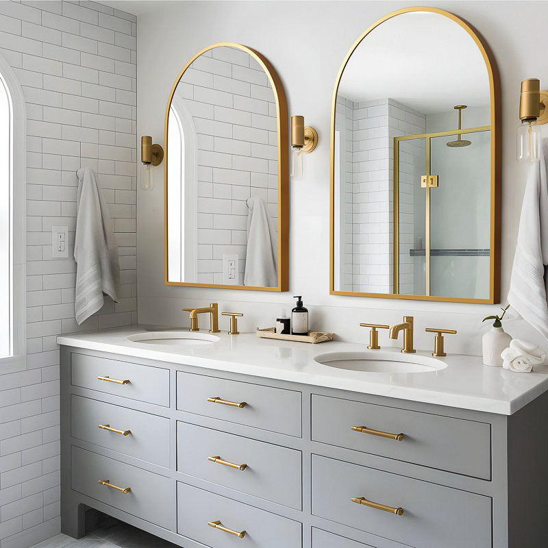 Gold arched mirrors over sinks in bathroom