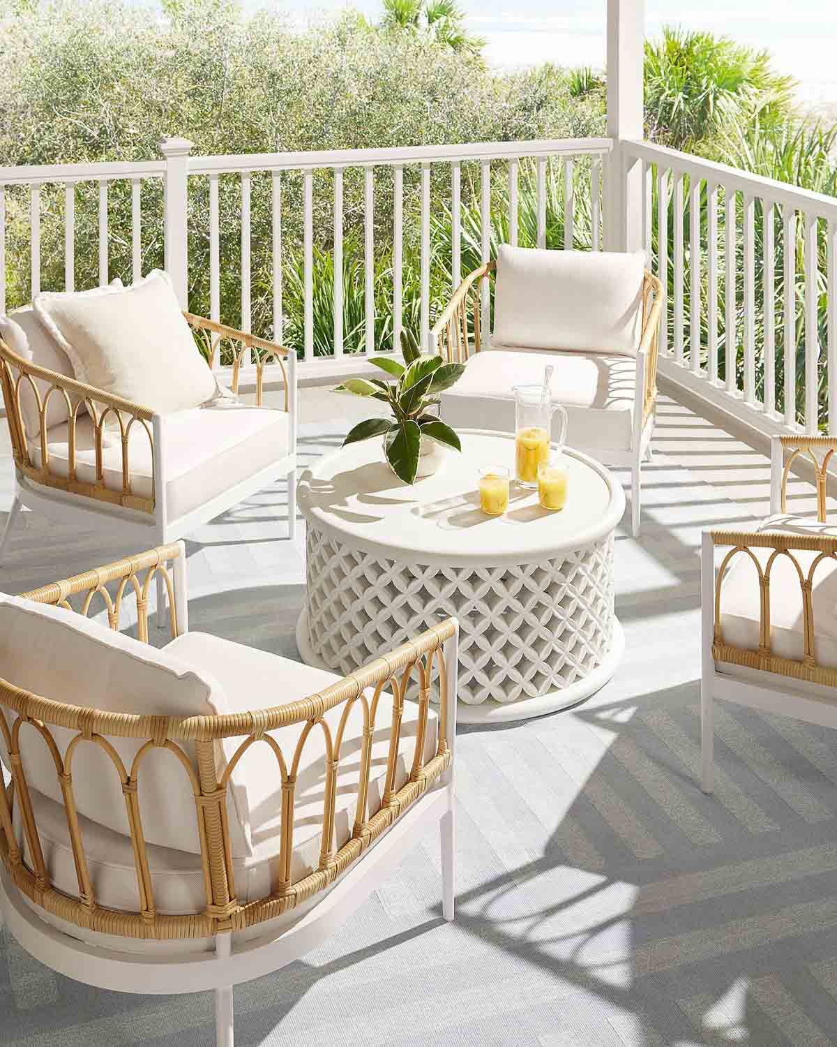 White lattice outdoor coffee table on deck with four chairs