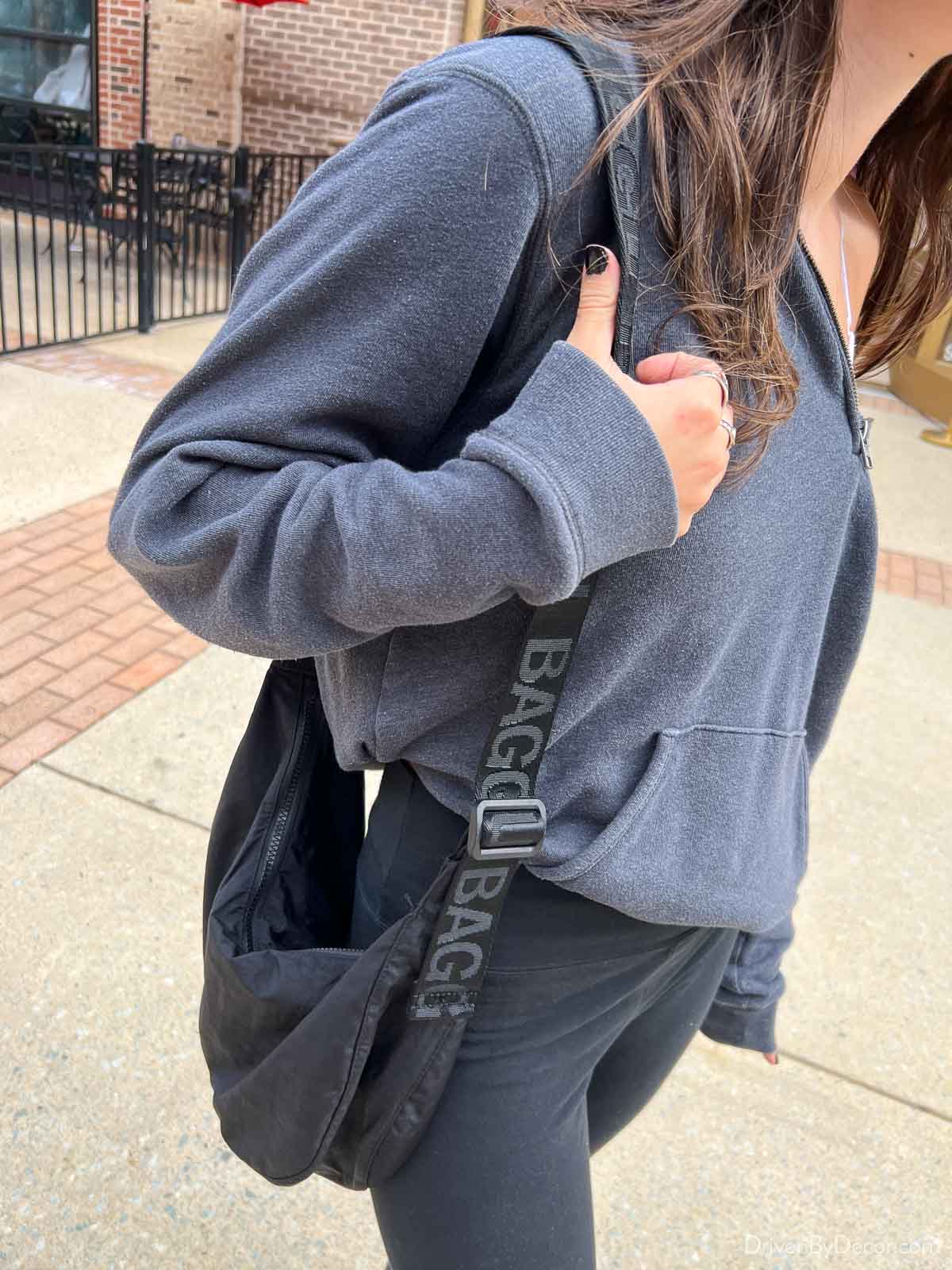 Black Baggu crescent bag on shoulder
